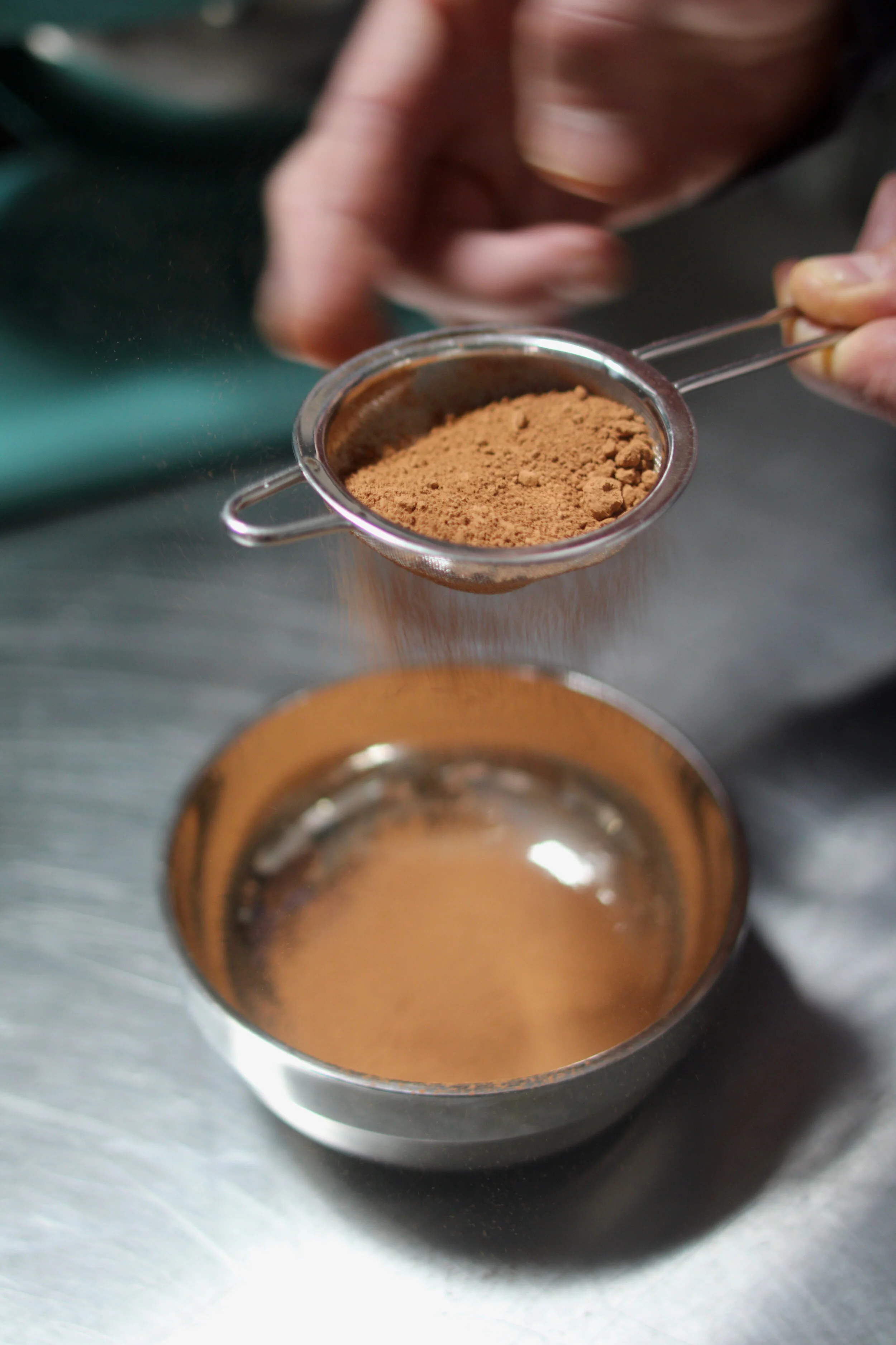 Sifting single-origin cocoa powder. Like the cacao it’s derived from, single-origin cocoa powder has equally distinctive flavor notes. Photo by Callie Neylan.