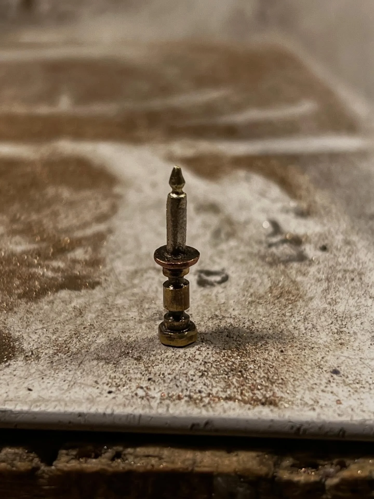 Candle lit dinner. Tiny fabricated candle made from three metals and five pieces.