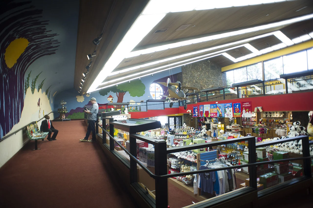 Brad and Robby shooting in the gift shop. All of the architecture is so wonderfully late 60's and early 70's, and those colorful murals are made out of carpet! 