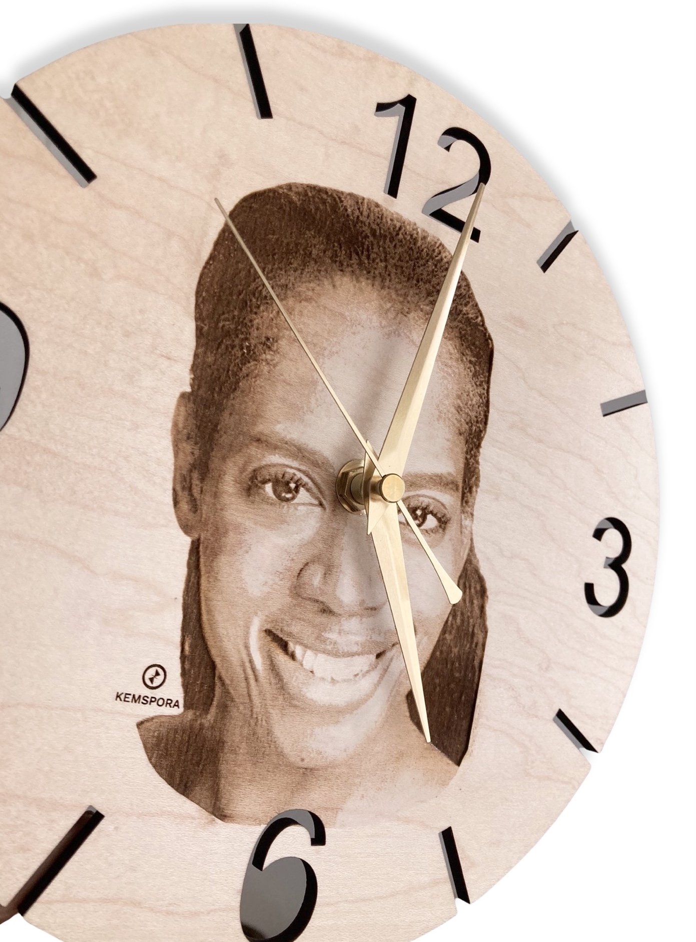 A Kemspora custom art laser engraving, on a uniquely stylish circular wooden clock face, of a woman's head, smiling with long hair. The clock is viewed on an angle.