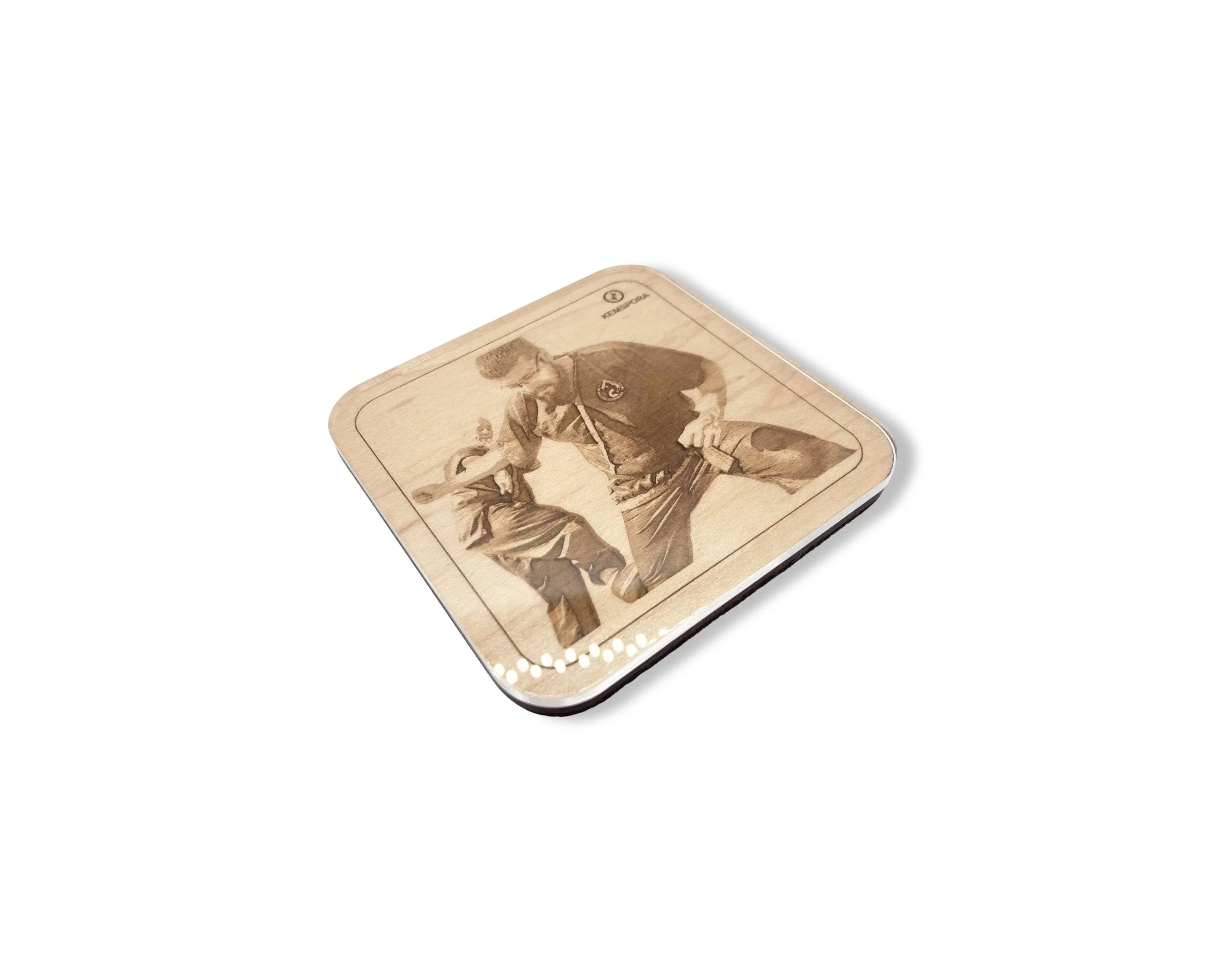 A Kemspora custom art laser engraving, on a uniquely stylish square wooden coaster, of a man and a woman performing a kung fu technique. Coaster has a clear acrylic covering.