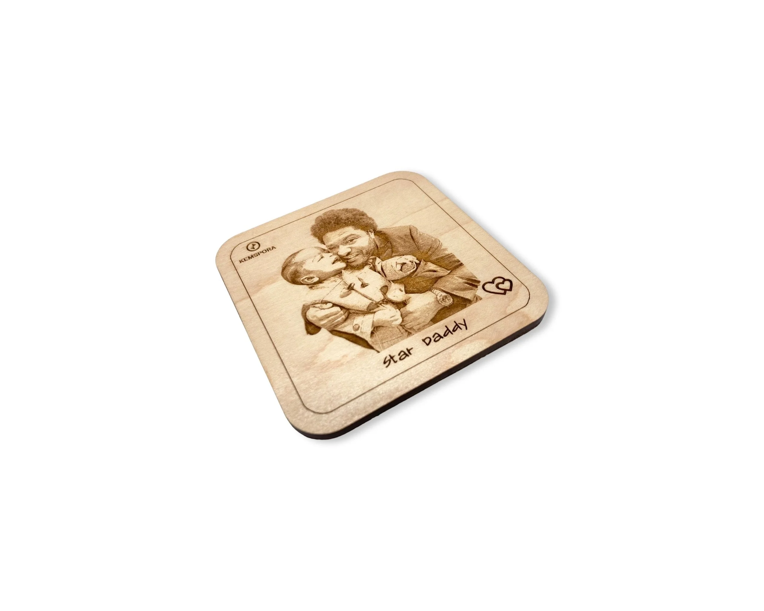 A Kemspora custom art laser engraving, on a uniquely stylish square wooden coaster, of a father hugging his son. Text on coaster reads Star Daddy.