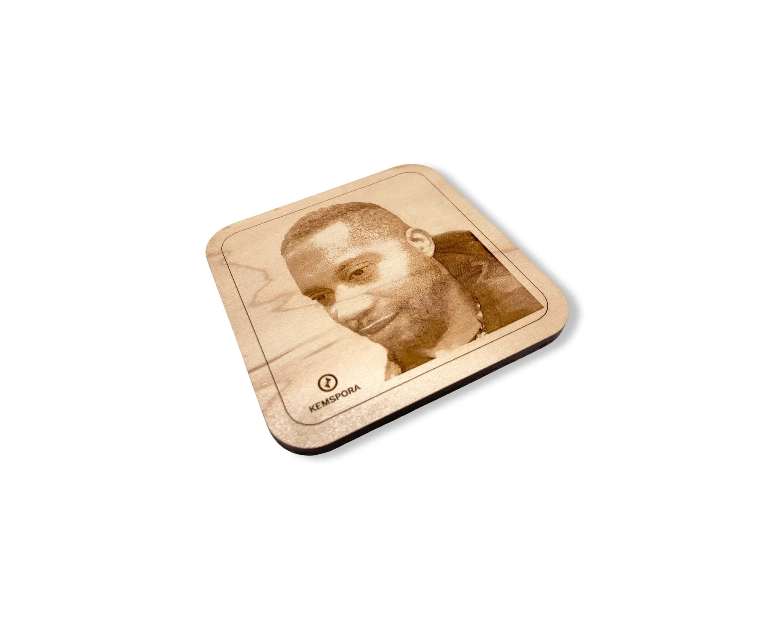 A Kemspora custom art laser engraving, on a uniquely stylish square wooden coaster, of a man with a short hair cut, smiling.