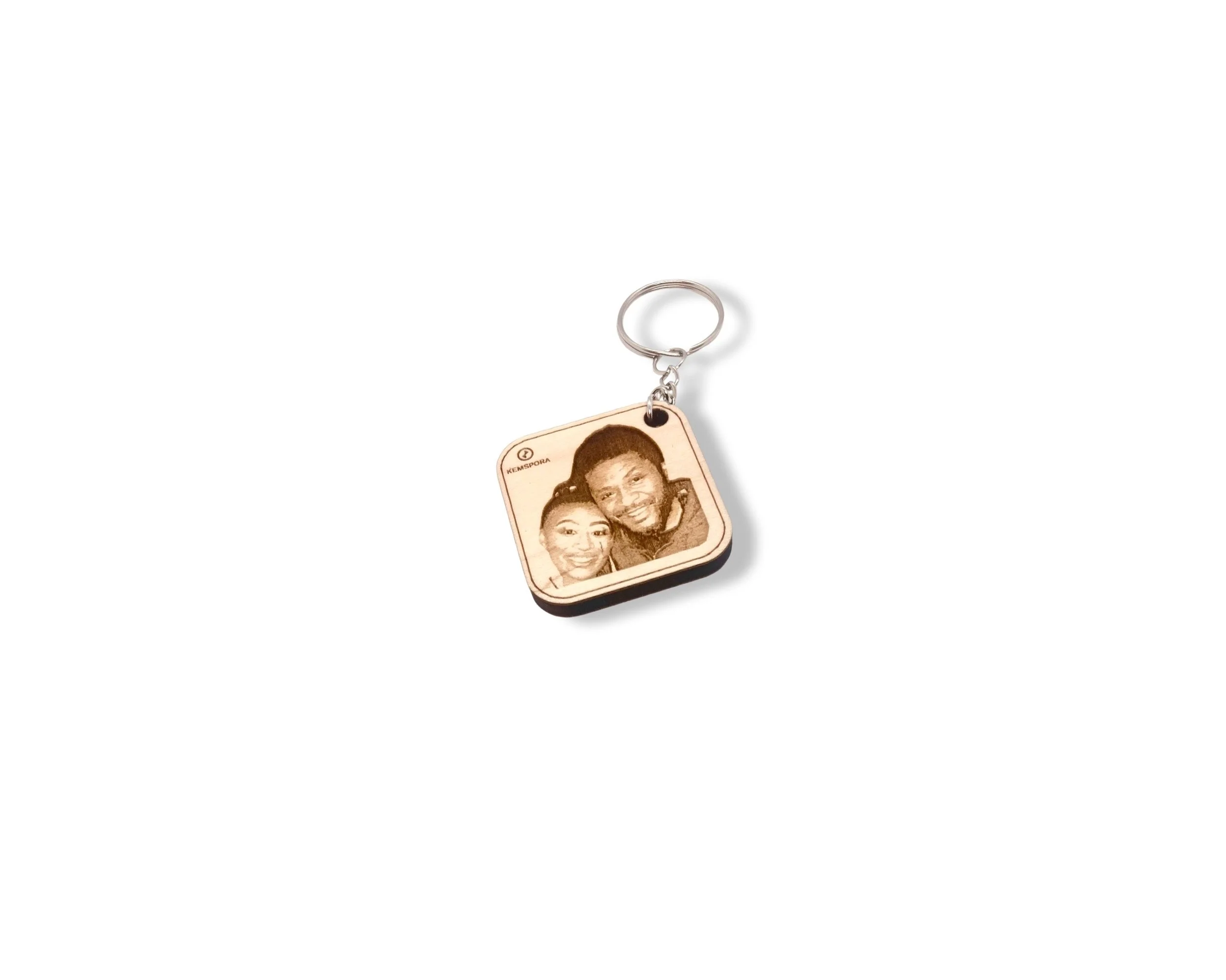 Kemspora custom art laser engraving, on a beautiful square, wooden, keyring, of a father and daughter hugging and smiling.