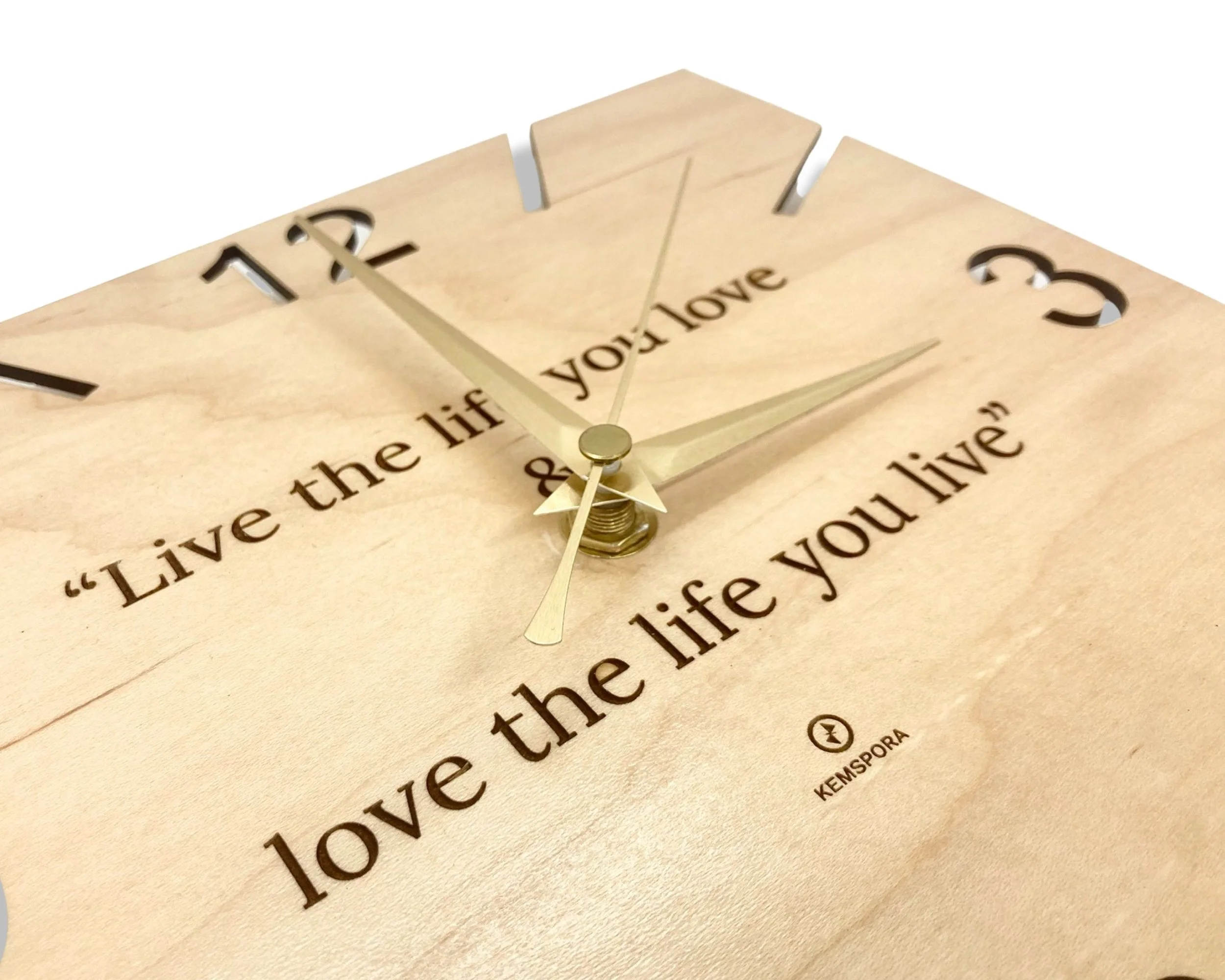 A Kemspora custom art laser engraving, on a uniquely stylish square wooden clock face, with text reading, live the life you love and love the life you live. Viewed on an angle.