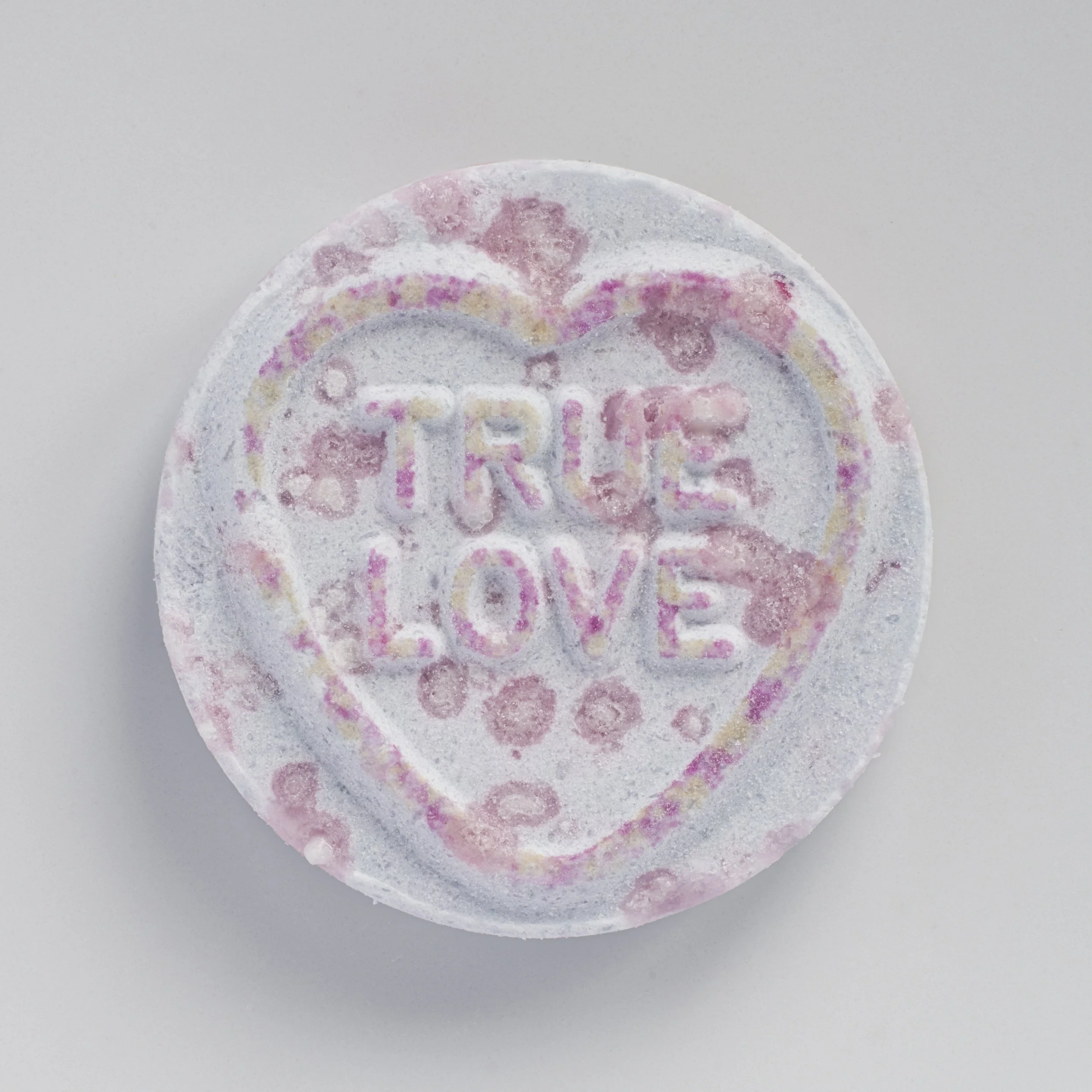   True Love, 2026    Sweet - A series focused on love and its raw, imperfect beauty. Time handled candies, worn yet sweet, mirror the way love marks us—shaping, scarring, yet still giving joy. Their tiny imprinted messages, simple but powerful, hold 