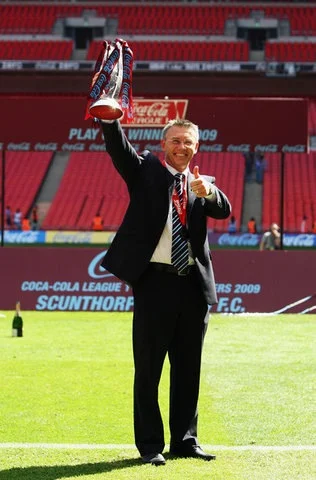 Holding the League One play-off trophy after beating Millwall 3-2 at Wembley in May 2009
