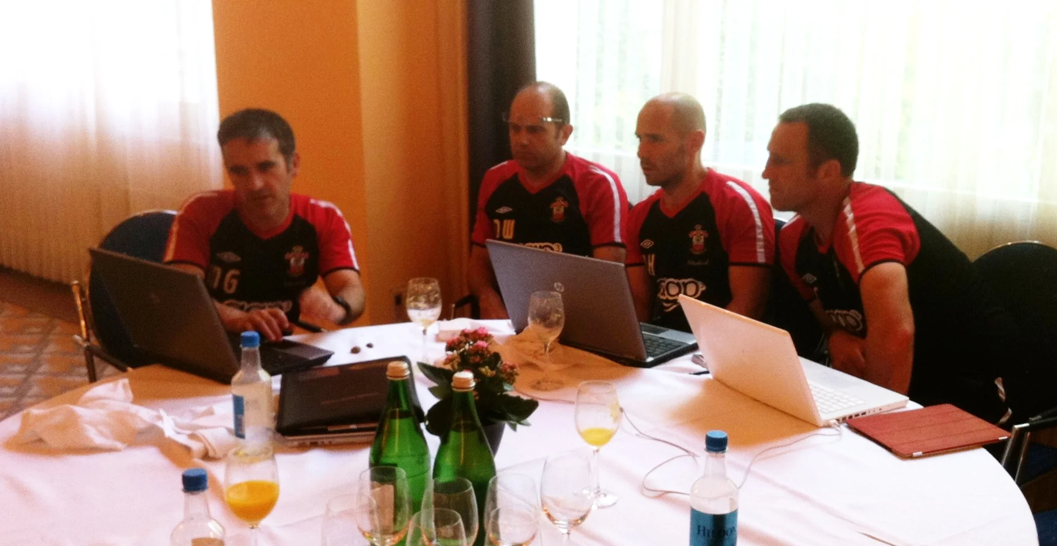 Left to right. Mo Gimpel Head of Medicine and Sport Science. Dean Wilkins 1st Team Coach. Nick Harvey 1st Team Head of Sport Science. Andy Crosby Assistant Manager. Collaboration. Discussing the players daily morning wellness scores during Southampton's 2011 pre-season tour to Interlaken in Switzerland.