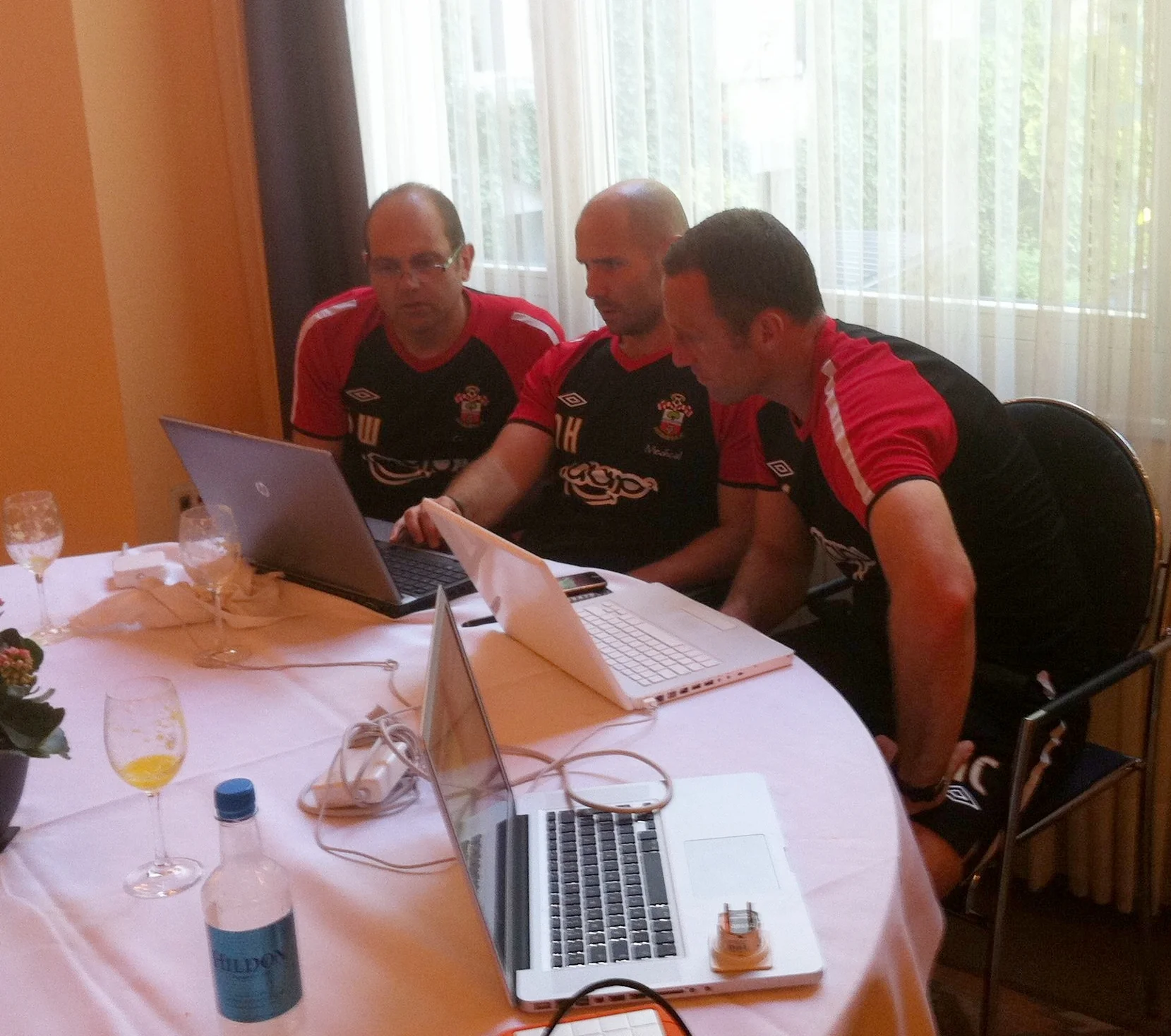 Collaboration between the Coaches in finalising the planning for the morning training session during Southampton's 2011 pre-season tour to Interlaken in Switzerland. From the left 1st Team Coach Dean Wilkins, Head of Sport Science Nick Harvey and Assistant Manager Andy Crosby.