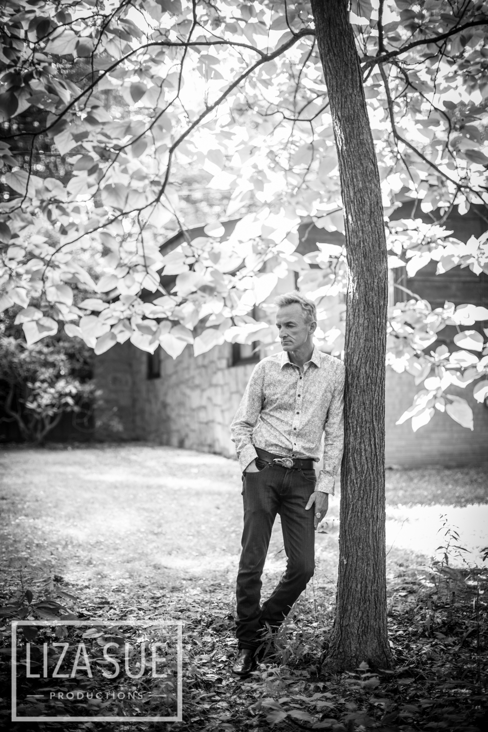 male on tree executive headshot outdoors nature