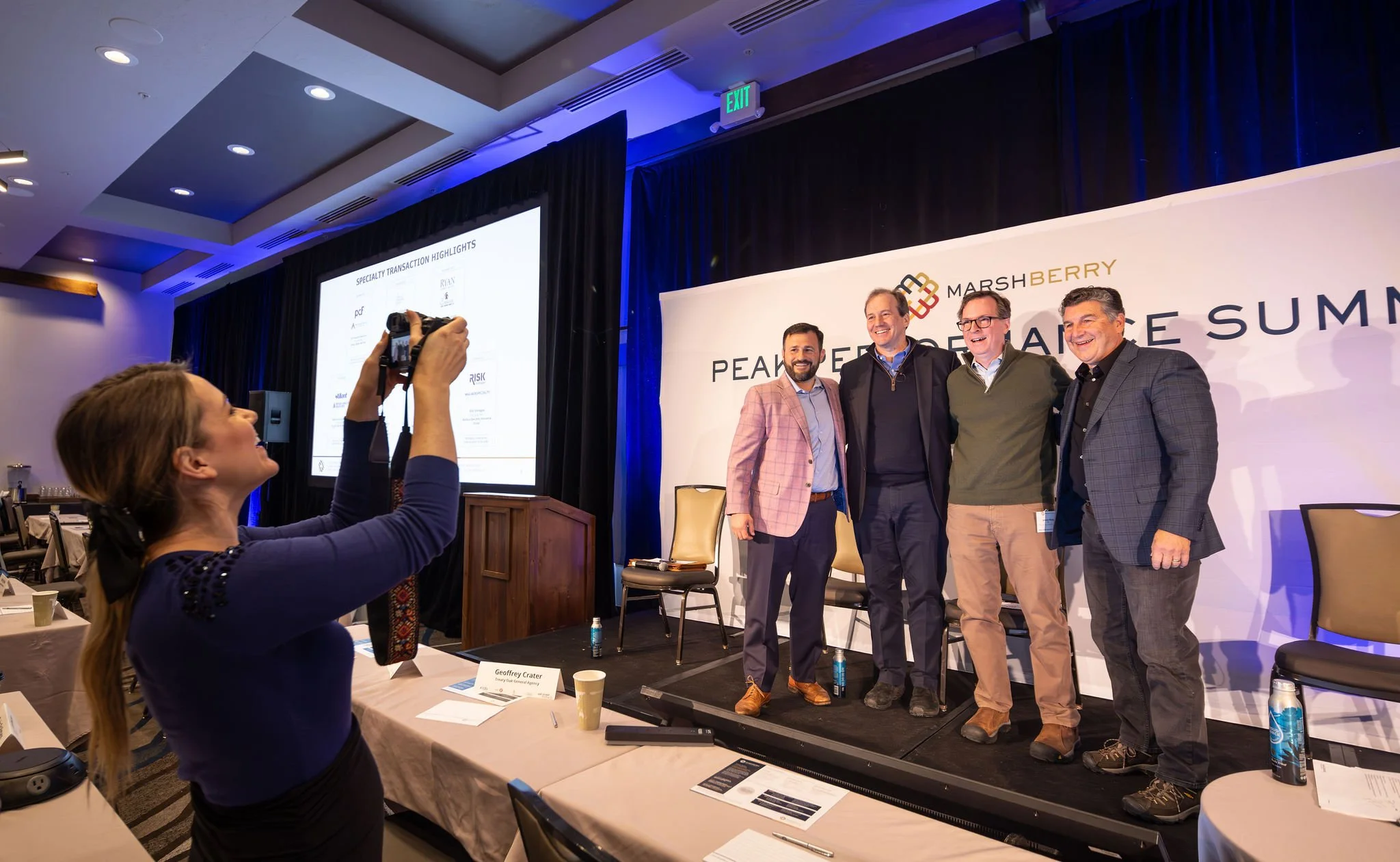 behind the scenes event photographer capturing group team shot of leaders and speakers