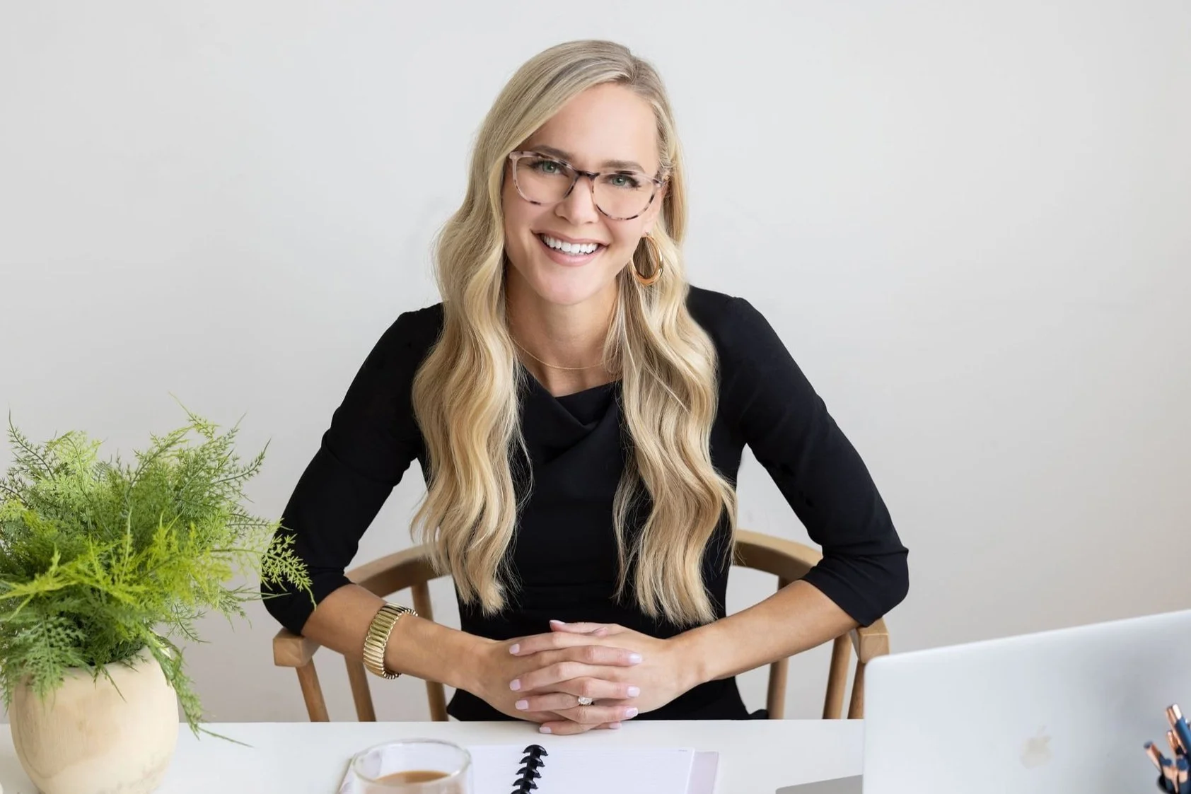 Lifestyle headshot of a woman working at a desk, capturing a natural, professional moment for personal branding and business content.