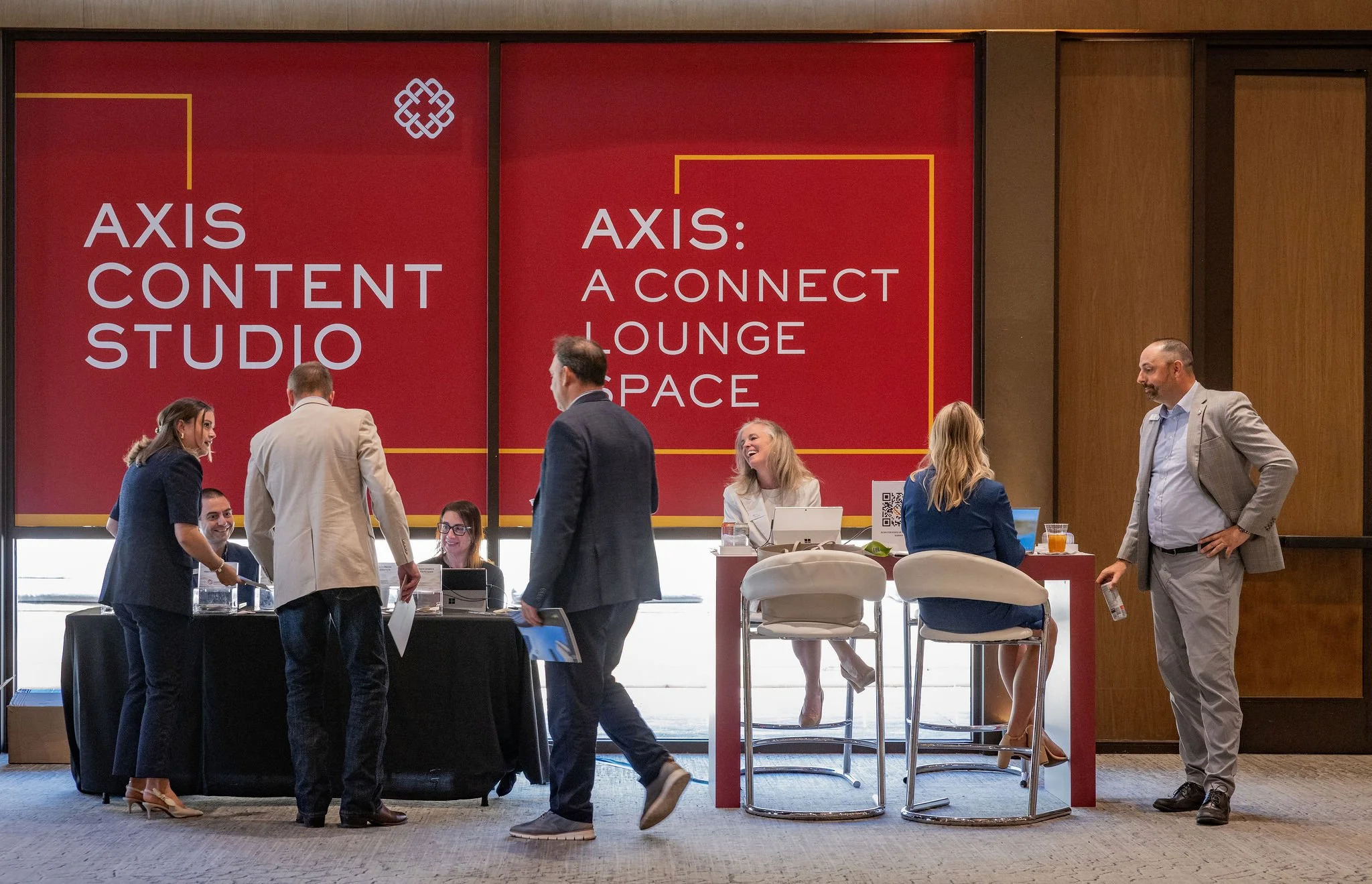 Attendees networking in the Axis Content Studio and Connect Lounge space at a corporate conference