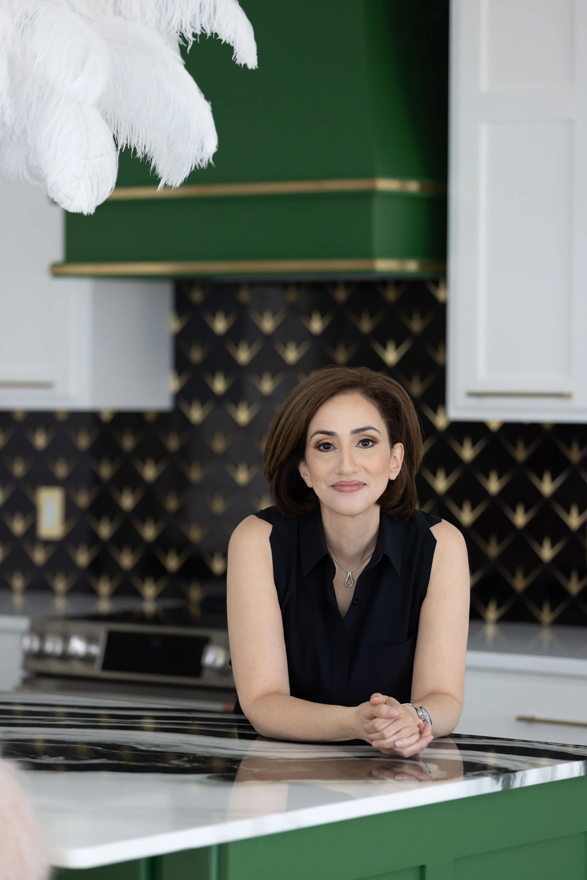 Lifestyle branding headshot of female business owner in modern kitchen workspace, professional brand photography in Cleveland Ohio