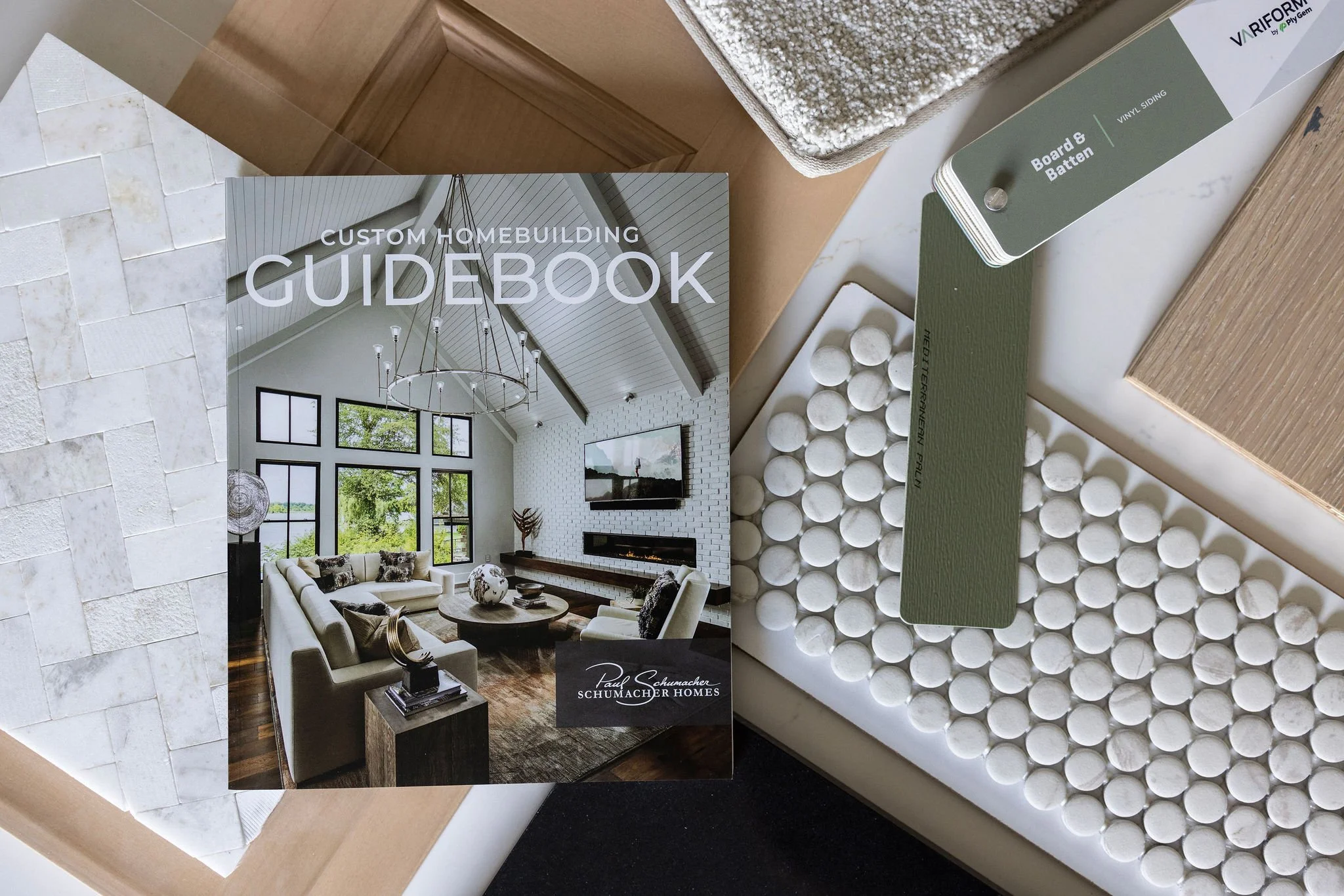 Flat lay photography of a catalog with builder samples, highlighting materials, color palettes, and design details for brand and product marketing.