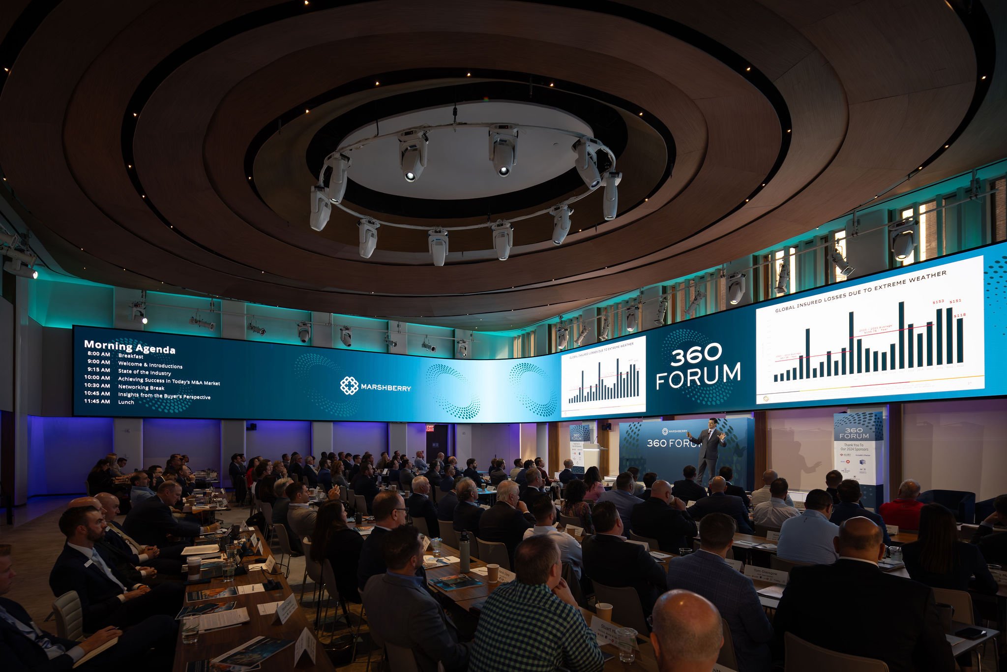 wide angle overview of packed corporate event financial insurance industry