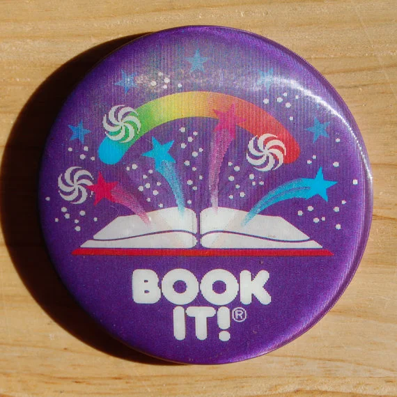 I proudly wore my Book It! pin. You earned a gold star for each book you read. When you filled up your pin, you got a free personal pan pizza.
