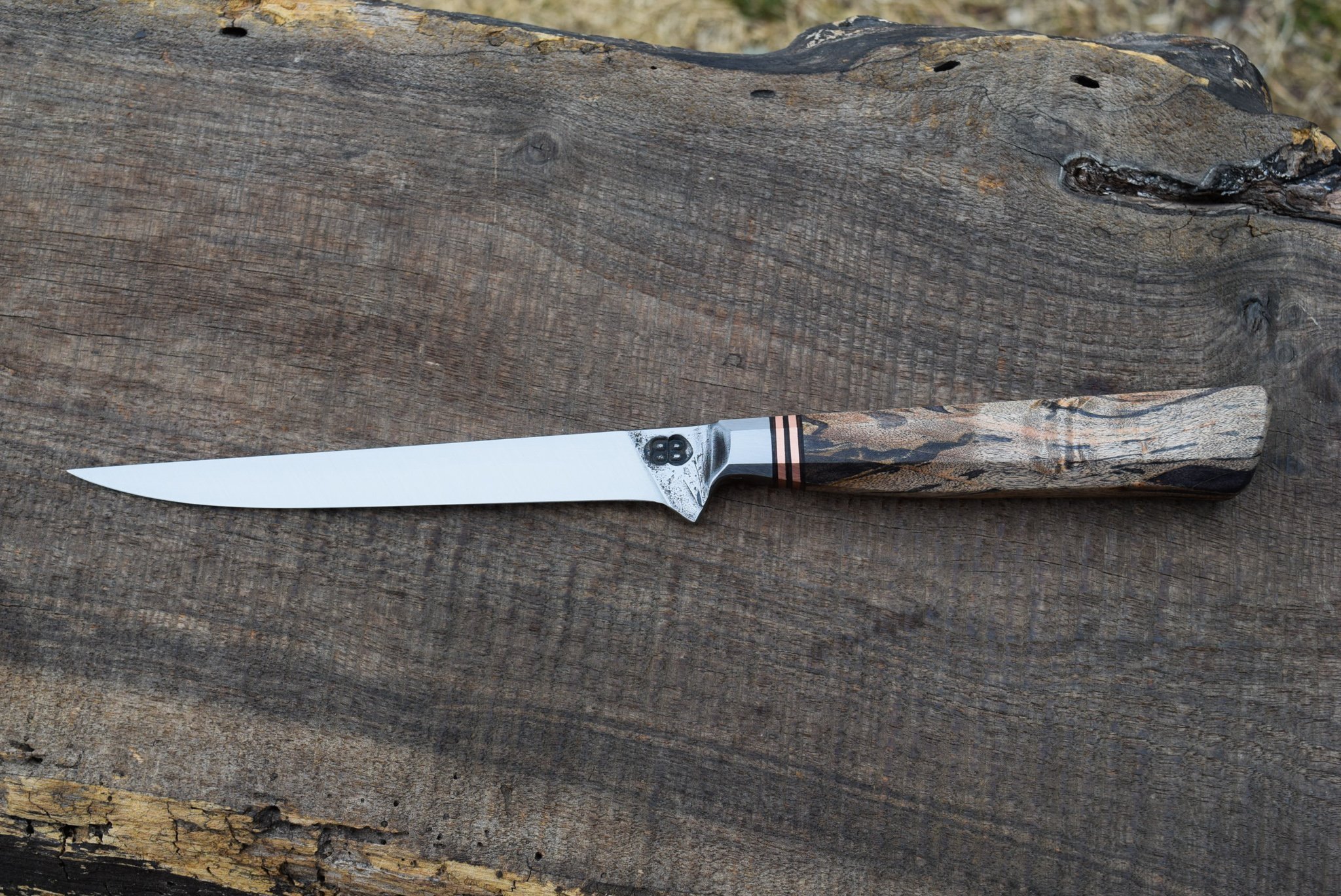  5.75" Integral Boning/Fillet with Forge Finish. Westernized Octagonal Black Maple Handle with Copper Spacers. 