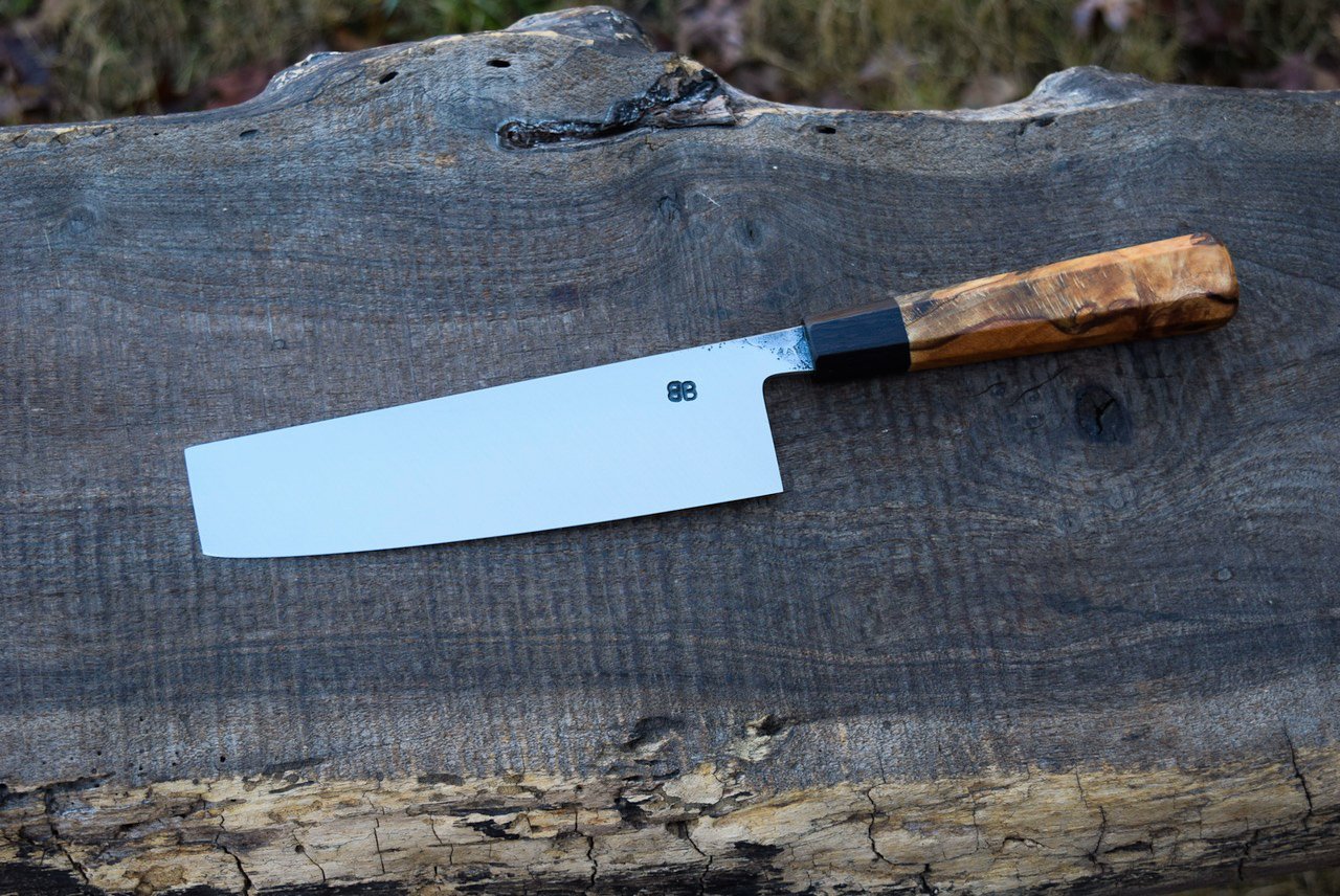  165mm Hidden-Tang Nakiri with some Forge Finish. Octagonal Spalted Copper Beech Handle with a Blackwood Ferrule. 