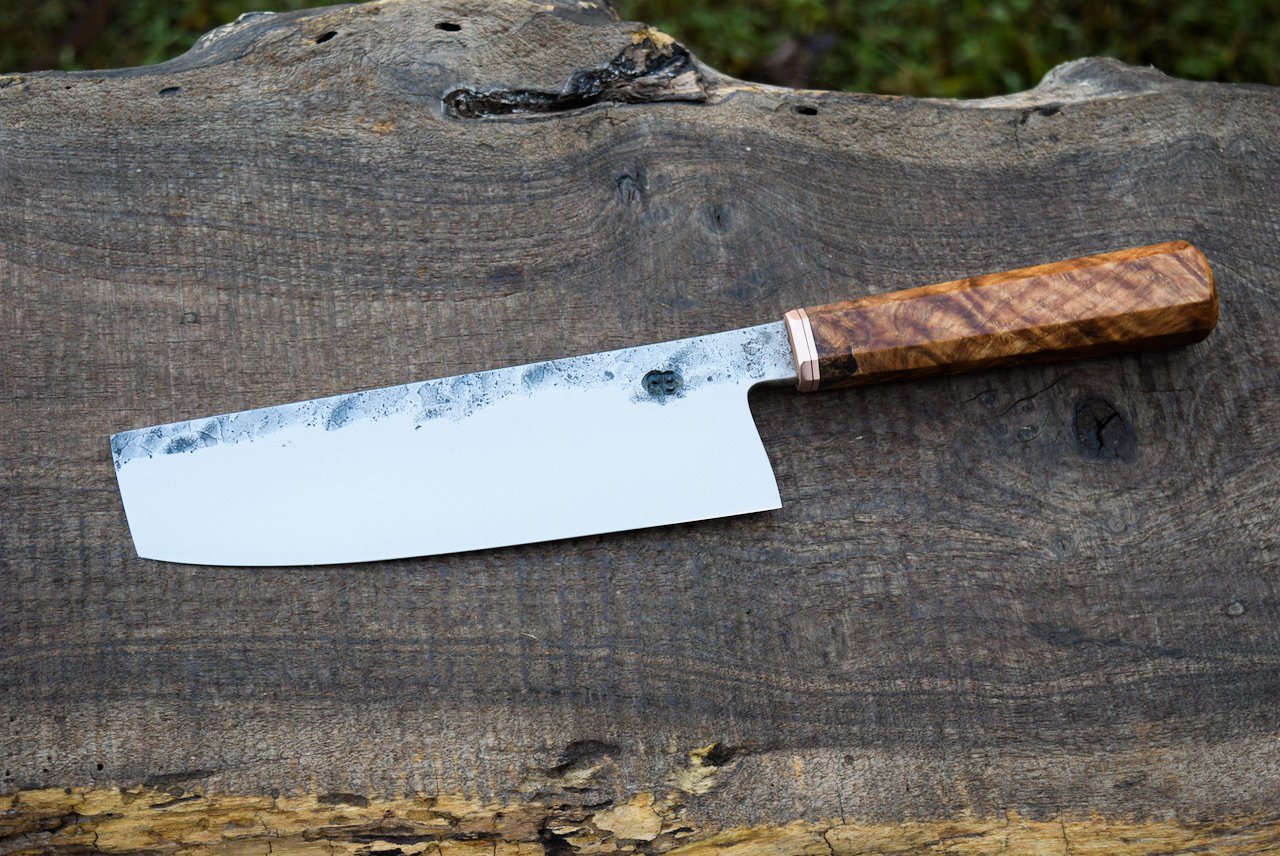  175mm Hidden-Tang Nakiri with Forge Finish. Octagonal Figured Copper Beech Handle with a Copper Faceplate and Spacer. 