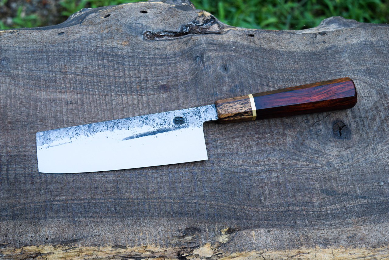  145mm Hidden-Tang Nakiri with Forge Finish. Octagonal Cocobolo Handle with a Spalted Walnut Ferrule and a Brass Spacer. 