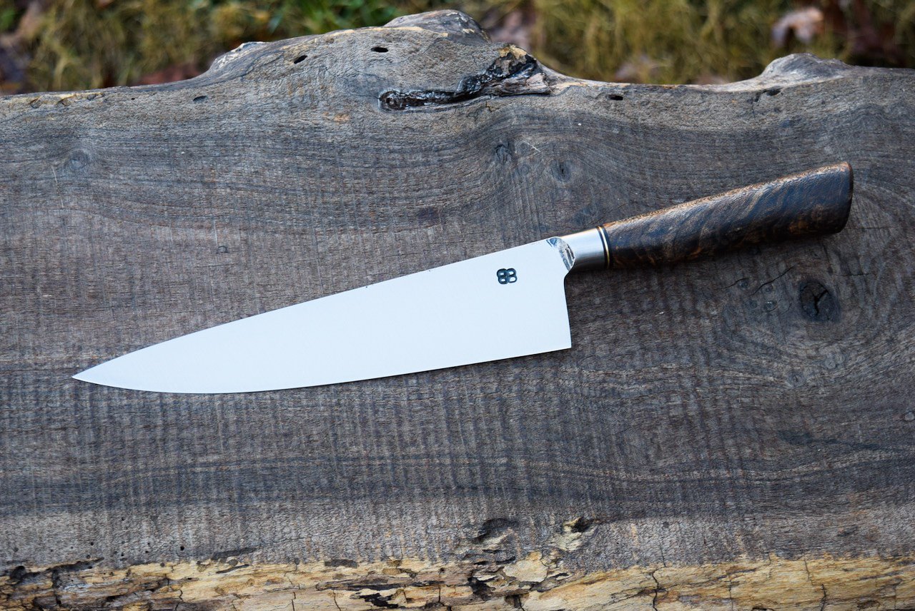  9” Integral Chef with some Forge Finish. Western Black Cherry Handle with a Bronze Spacer. 