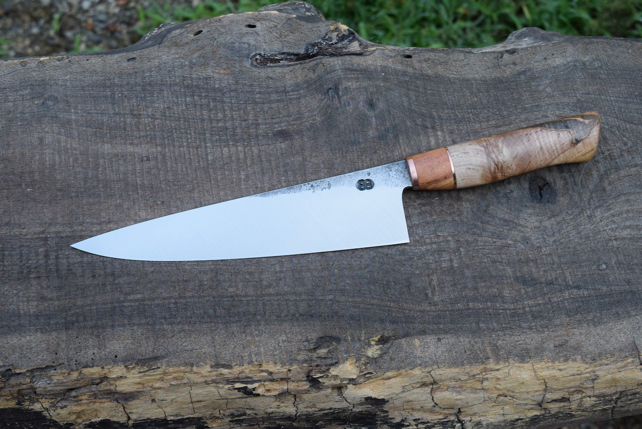  8.5” Hidden-Tang Chef with Forge Finish. Western Spalted Maple Handle with a Copper Faceplate and Mesquite and Copper Spacers. 