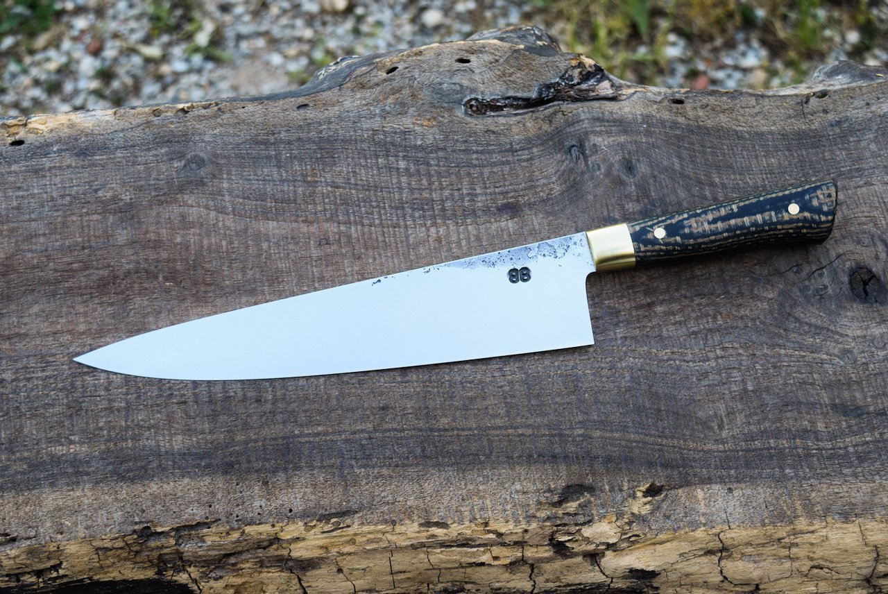  9.25” Full-Tang Chef with Forge Finish. Western Coffeebag and Linen Laminate Handle with Brass Bolsters and Pins. 