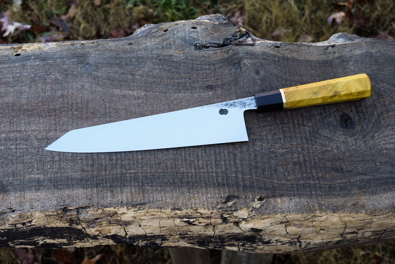  230mm Hidden-tang K-tip Gyuto with forge finish. Octagonal Mulberry handle with a Blackwood ferrule and a brass spacer. 
