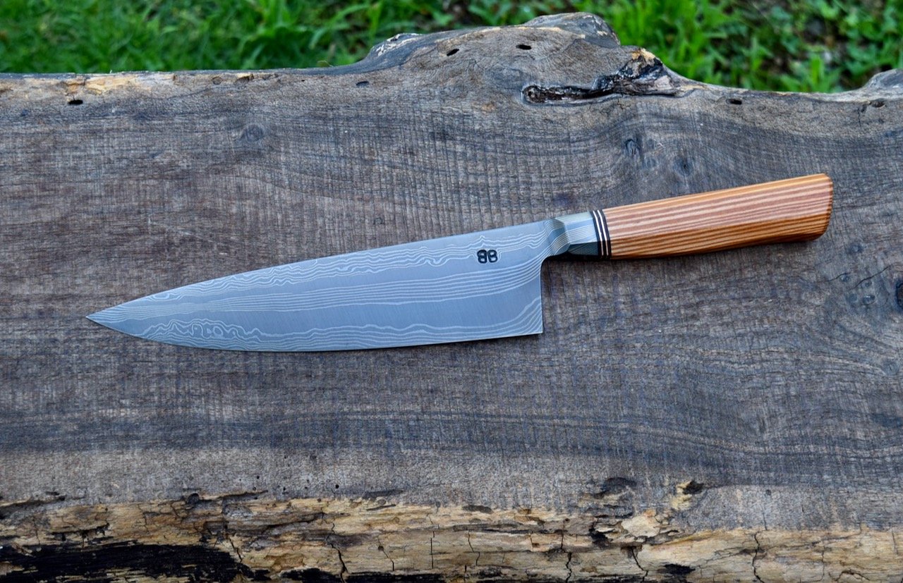  8.5” Integral Damascus Chef. Westernized Octagonal Heart Pine Handle with Bronze Spacers.  