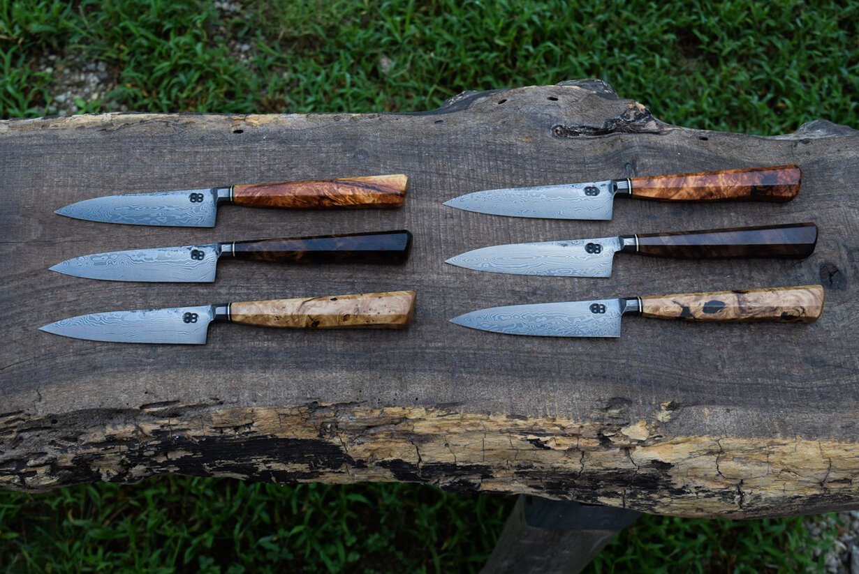  4.25” Integral Damascus Steak Knives with Forge Finish. Westernized Octagonal Aspen Burl, Walnut Burl and Chestnut Burl Handles with Bronze Spacers. 