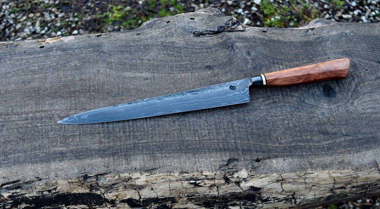  230mm Integral Damascus Sujihiki with Forge Finish. Westernized Octagonal Cherry Burl Handle with a Brass Spacer.  