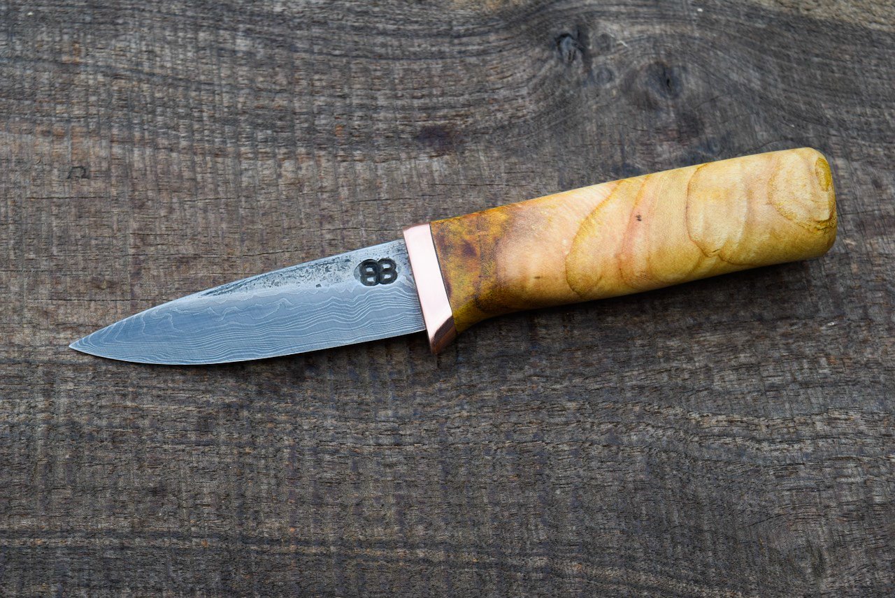  3.25” Damascus Belt Knife with Forge Finish. Copper Guard and Redbud Burl Handle.  