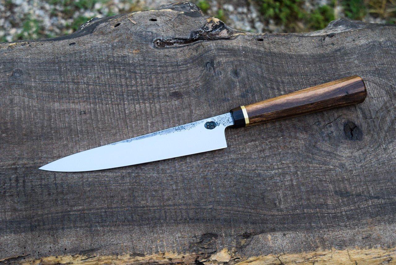  6” Hidden-Tang Petty with Forge Finish. Octagonal Redbud Handle with Blackwood Faceplate and Brass Spacer.  