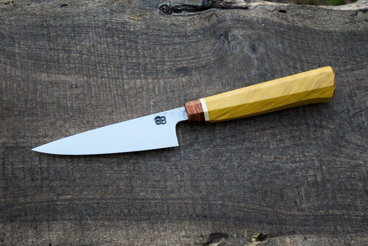  4.25” Hidden-Tang Paring with some Forge Finish. Westernized Octagonal Mulberry Handle with Bubinga Faceplate and Brass Spacer.  