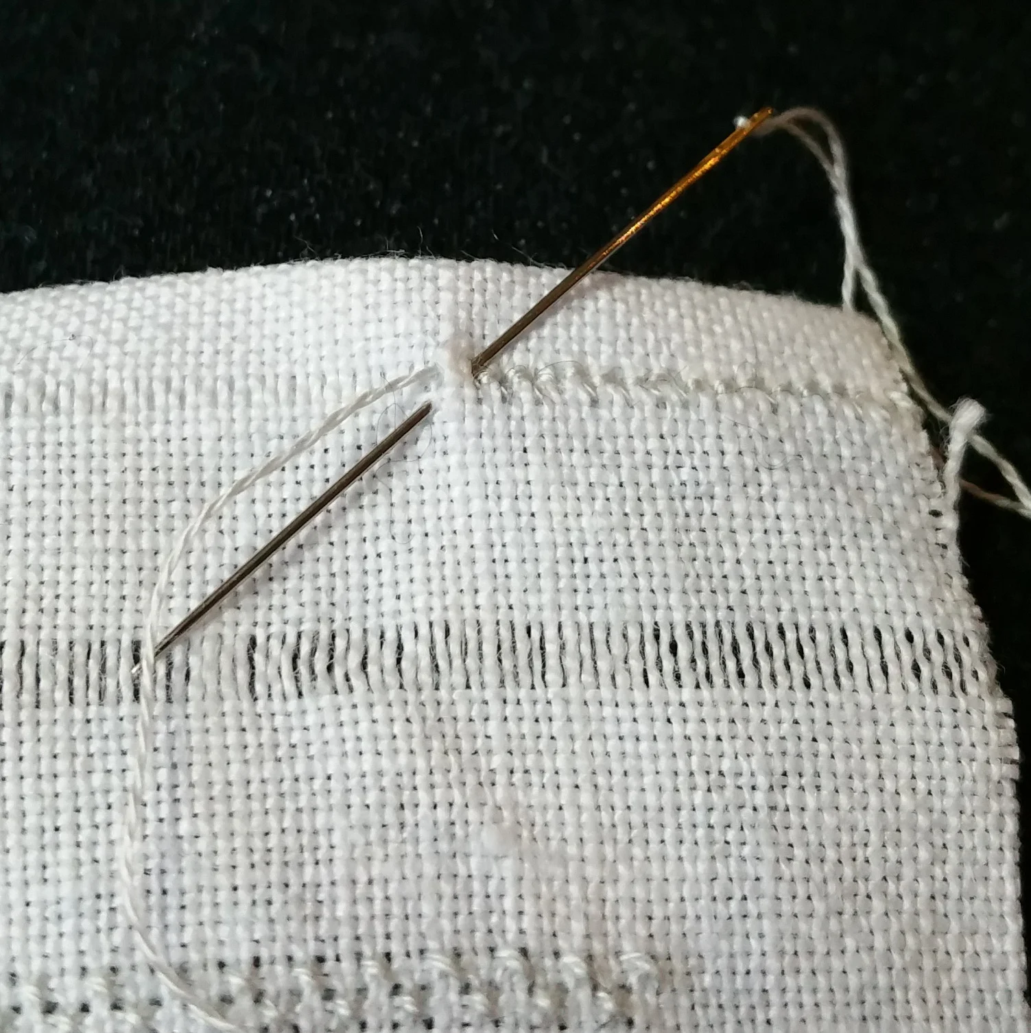Working the hemstitch - I found it easier to change over to a sharp needle for this, since I needed to catch the bit of the folded-over fabric in my stitches.