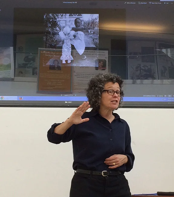 Ellen Frankenstein, gives a talk at Galluadet University as part of the tour.. She's projecting an image called "Kim with a Doll" from a documentary still series made in Barbados. Photo by Brian Greenwald.