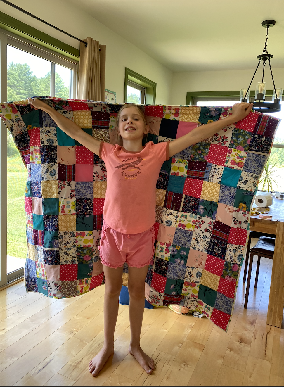 Mikaela quilt holding it.png