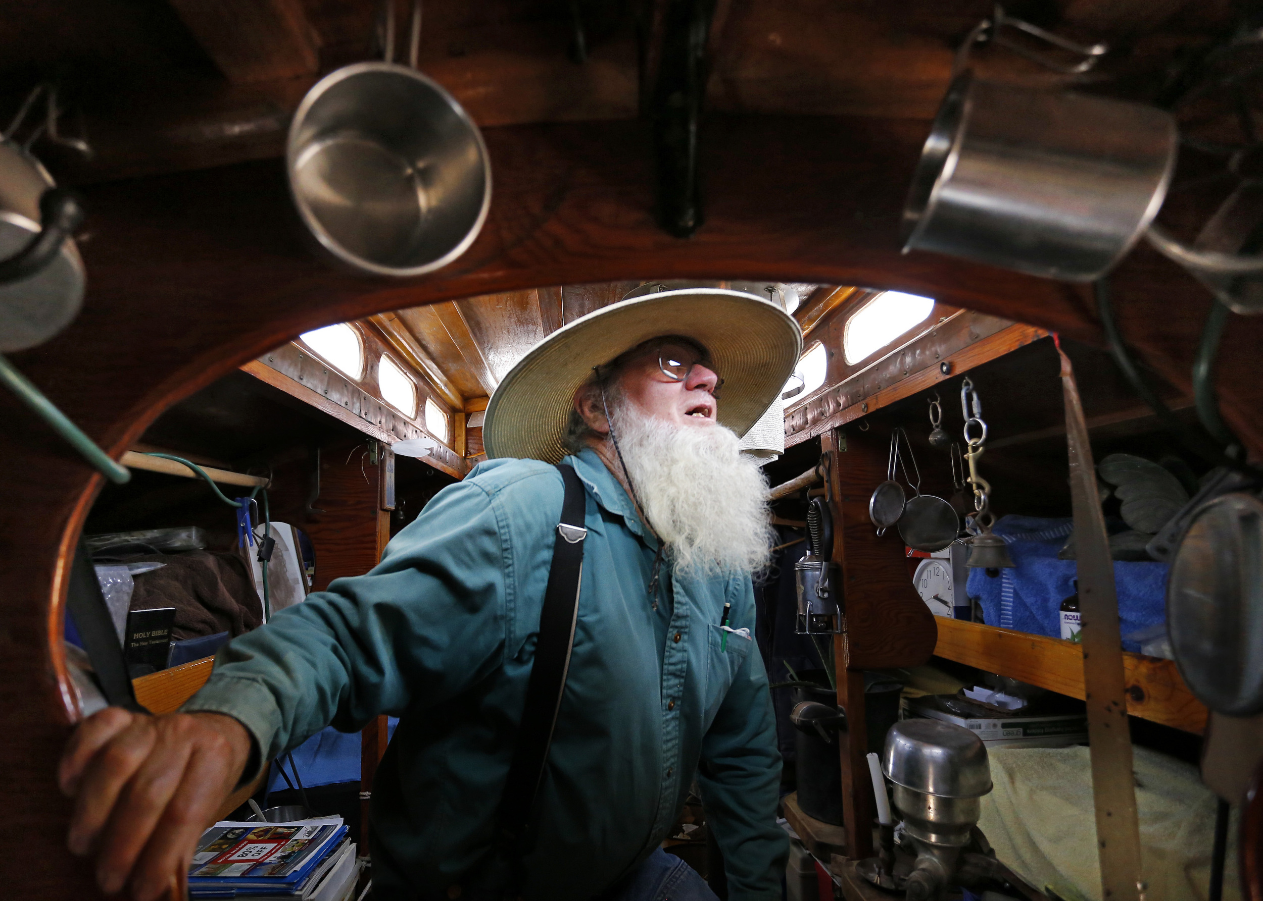  John Stiles walks through his living space in his first trailer at Hoffnungsau Mennonite Church in rural Inman, Kansas, on Wednesday, July 23, 2014. Stiles has been traveling the US for 35 years after leaving Arkansas in 1978 with a wagon and two mu