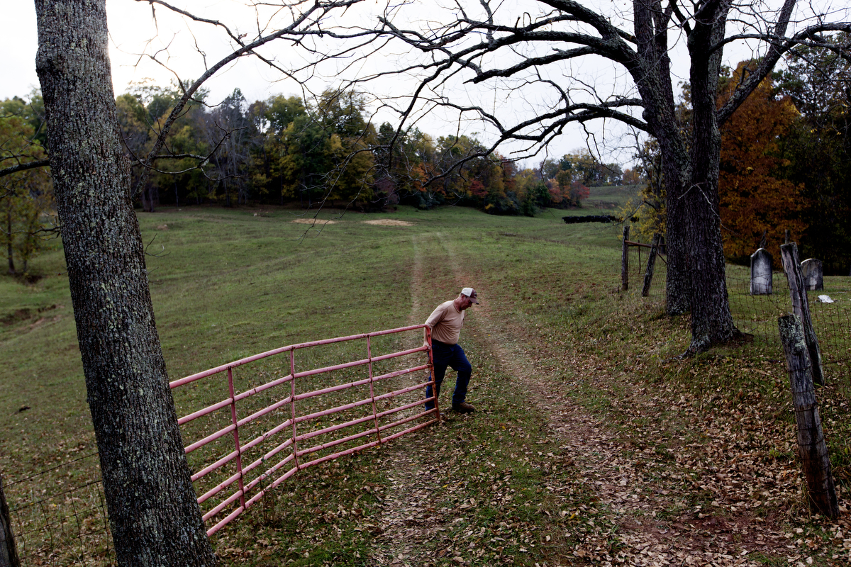  Southall closes the gate to one of his pasture fields. 