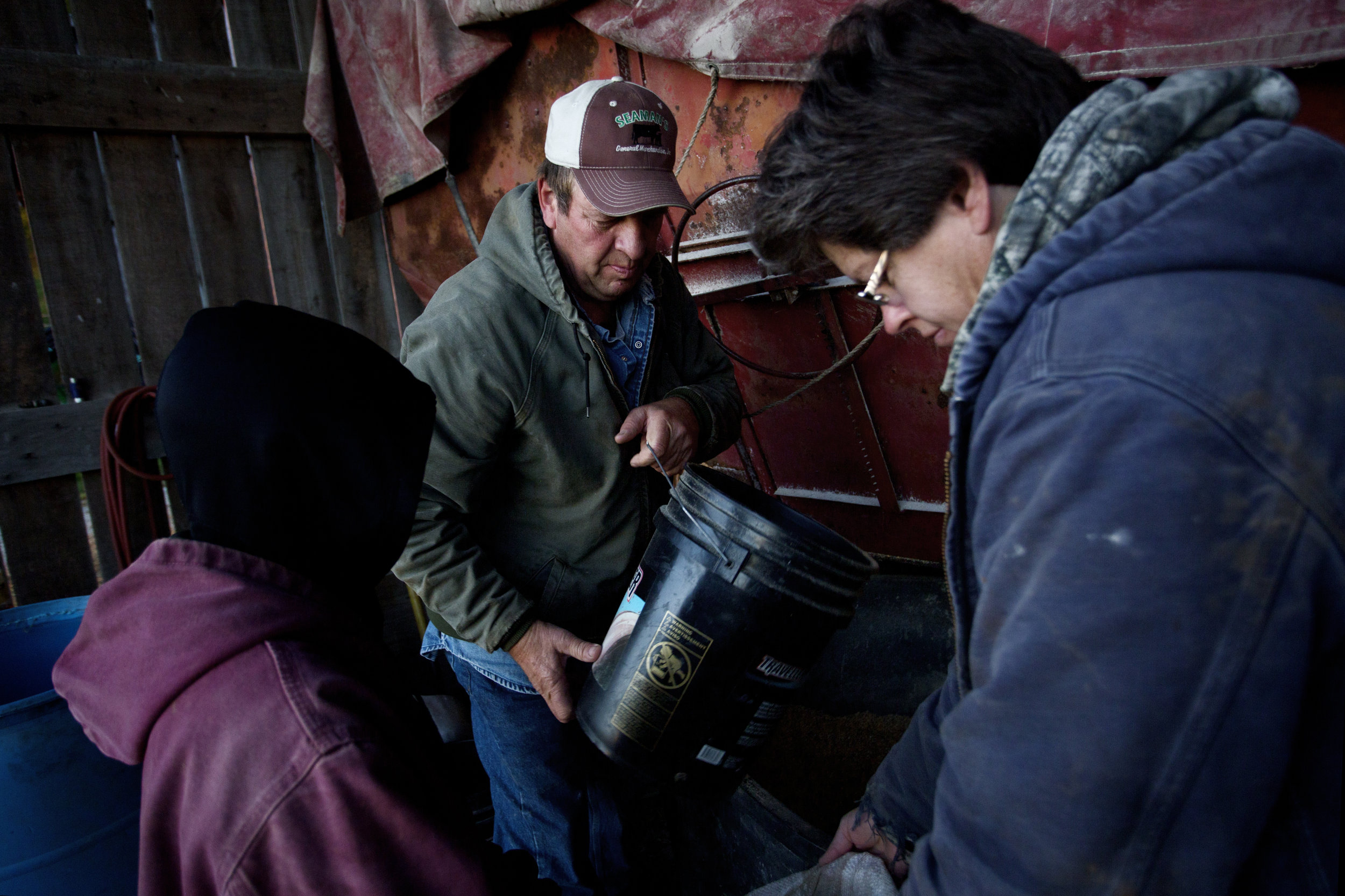  Southall and his wife Rhonda and grandson do early morning chores on a chilly morning. 