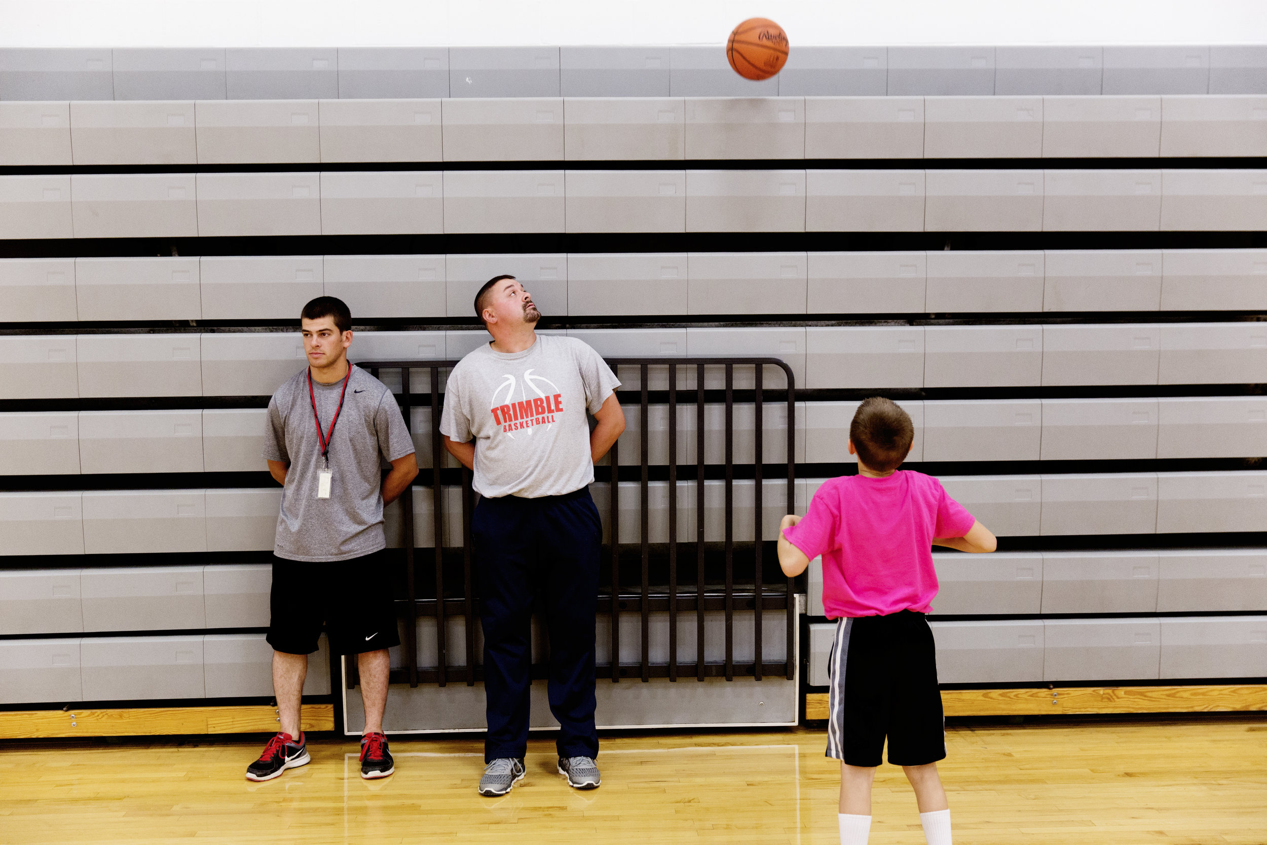  Reitano observes basketball practice as Steve Weber looks at Levi Weber's ball in the air. 