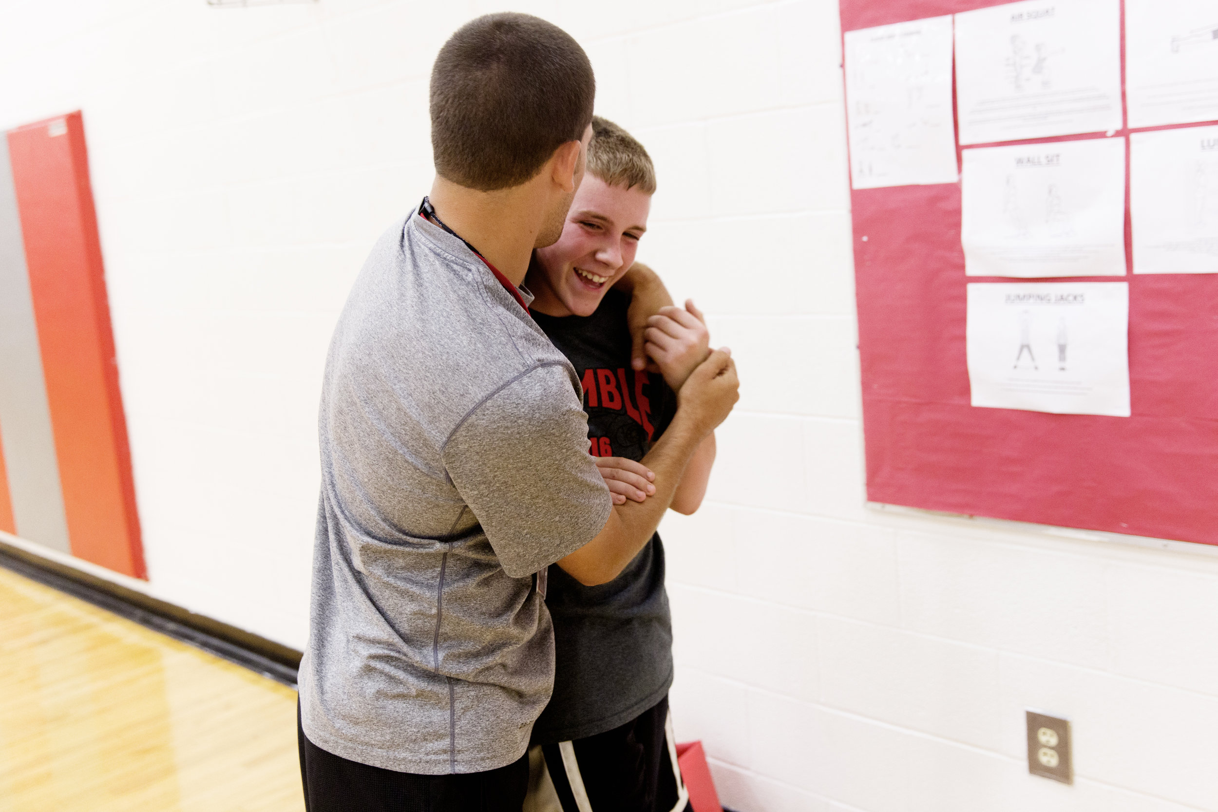  Reitano plays a joke on one of his players, Tyler, after team practice. 