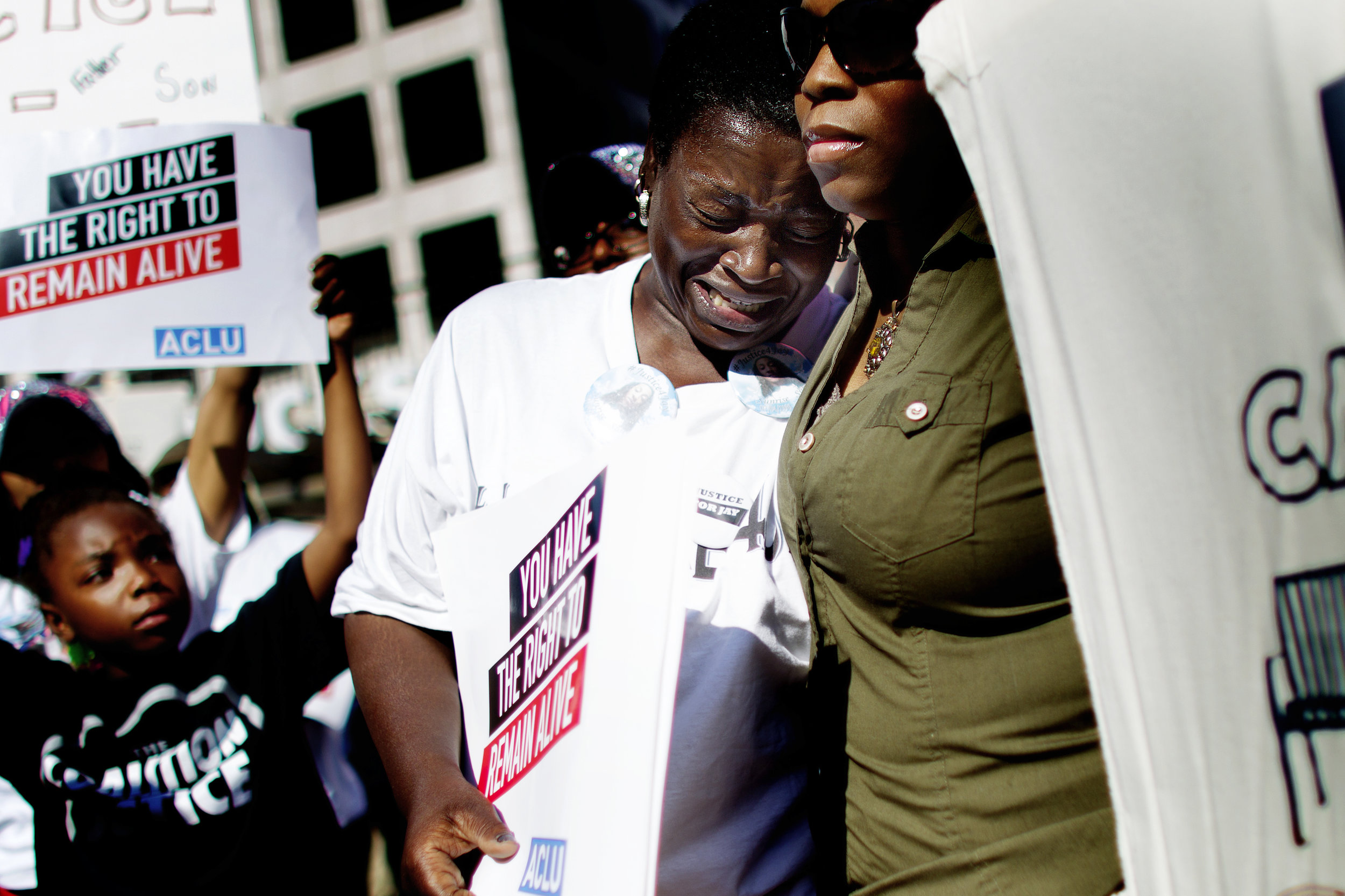 Gloria Speed, aunt of Jay Anderson, who was shot and killed by a Wauwatosa Police officer in the early morning hours of June 23rd, is comforted during a Coalition for Justice rally at Red Arrow Park in downtown Milwaukee.