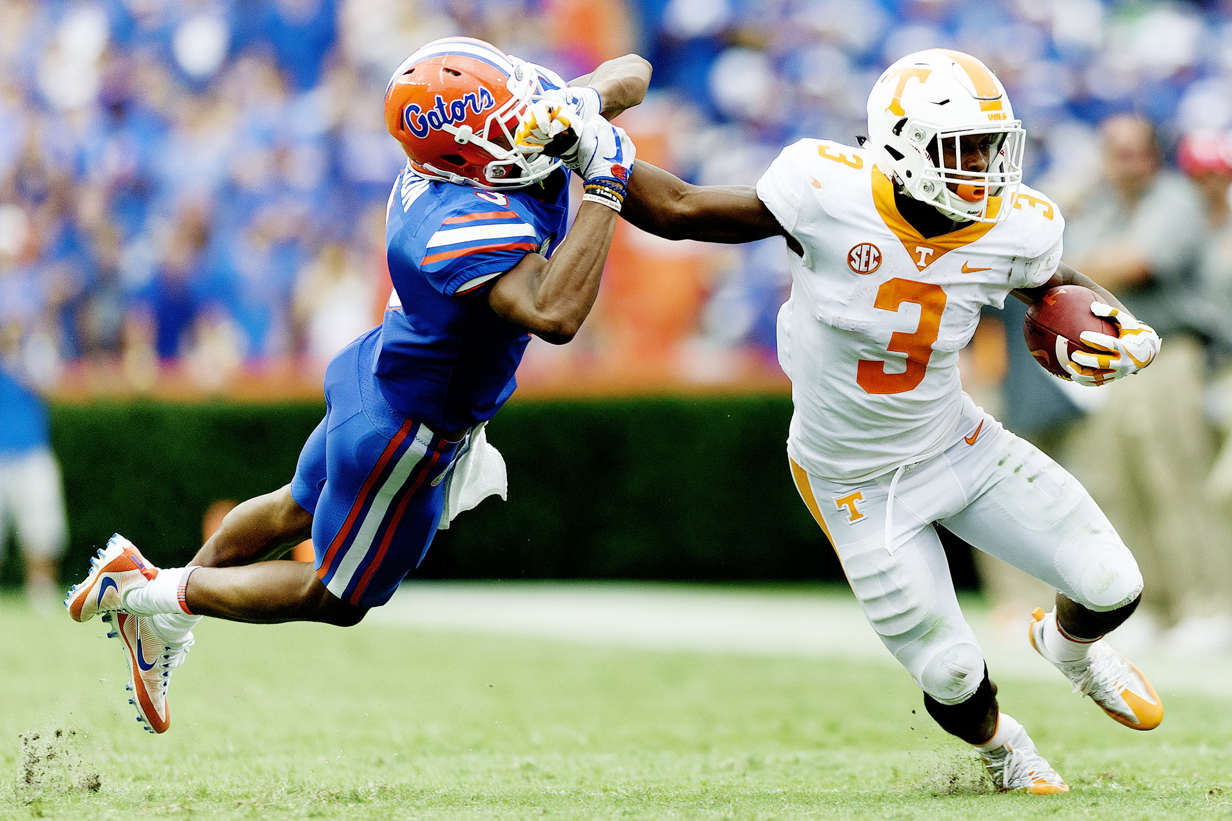 Tennessee running back Ty Chandler (3) pushes away Florida cornerback Marco Wilson (3) as he runs the ball down the field at Ben Hill Griffin Stadium in Gainesville.