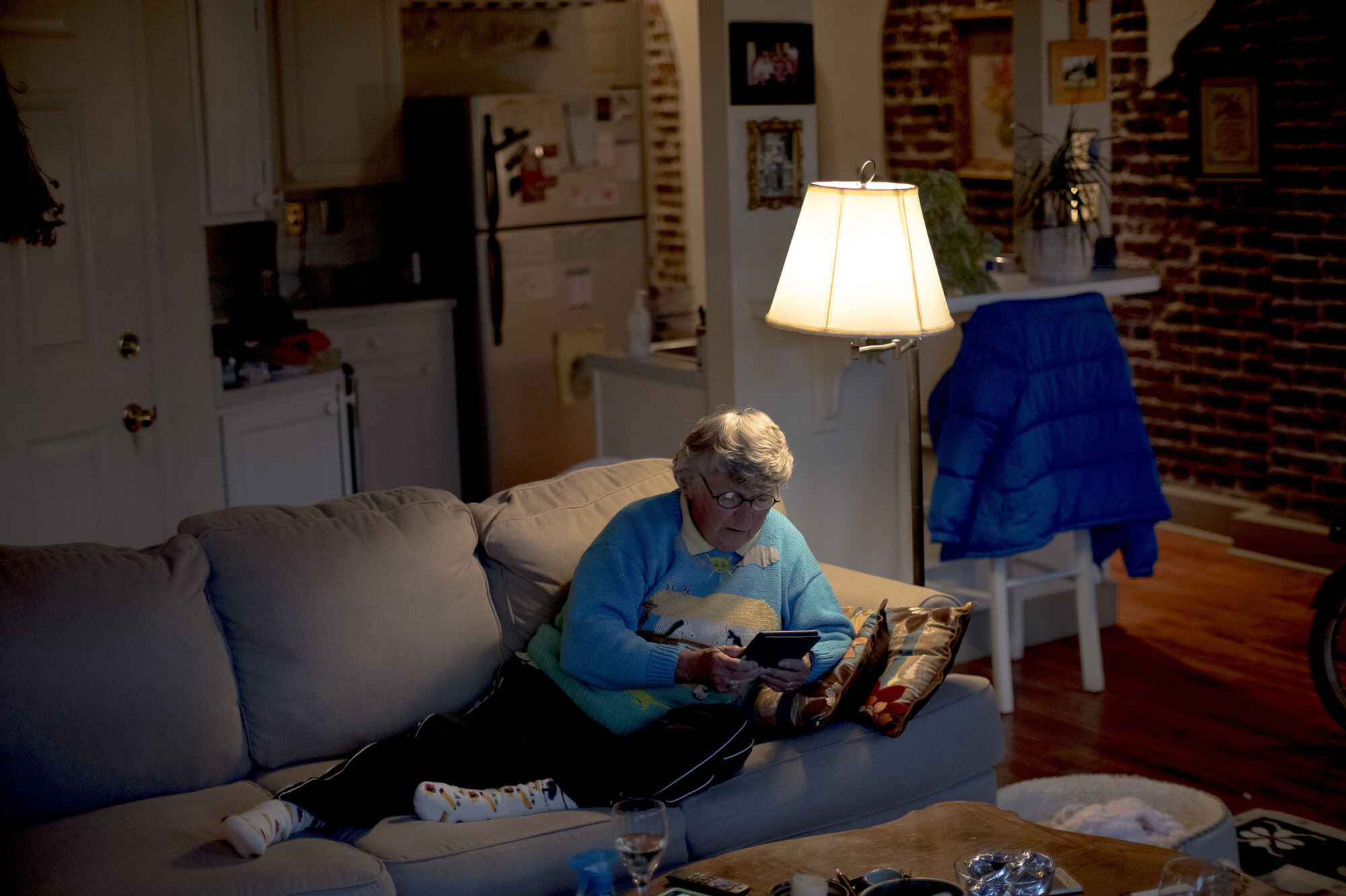  Patti Smith unwinds at the end of a long day with a glass of wine and reading a book on her Kindle in her Commerce Building condo on the 100 Block of Gay Street in Knoxville. Smith is the longest resident living on Gay Street. 