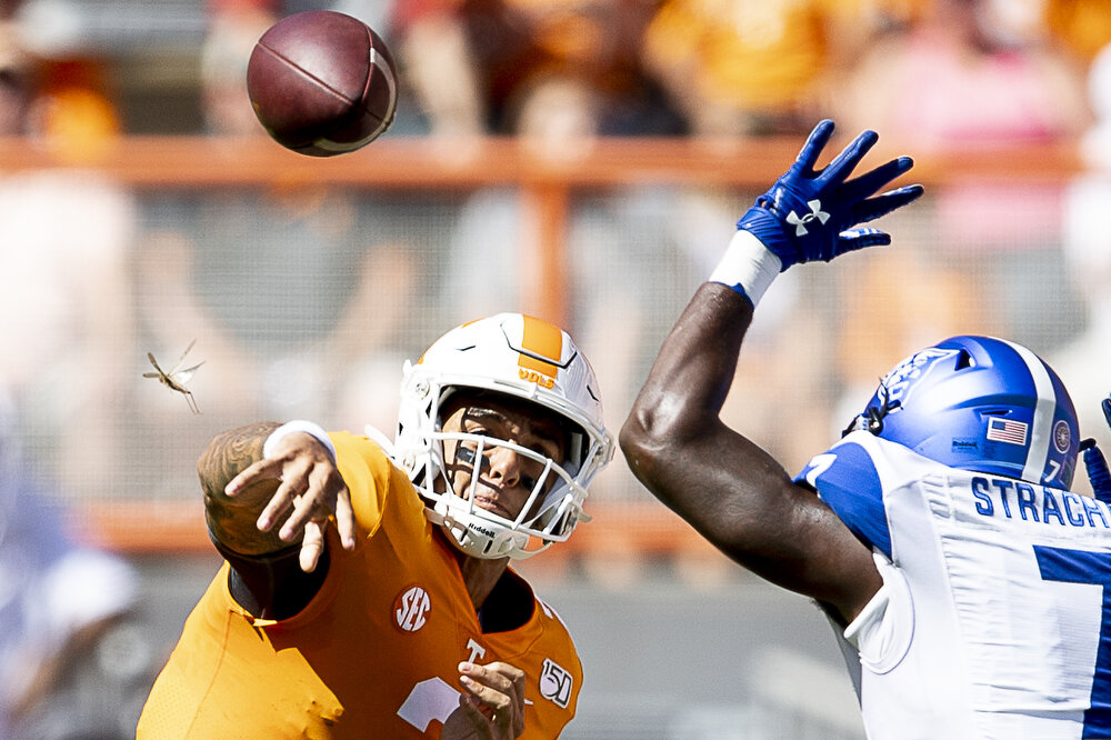  A bug flies off the shoulder of Tennessee quarterback Jarrett Guarantano (2) as he throws a pass during a game against Georgia State at Neyland Stadium. 
