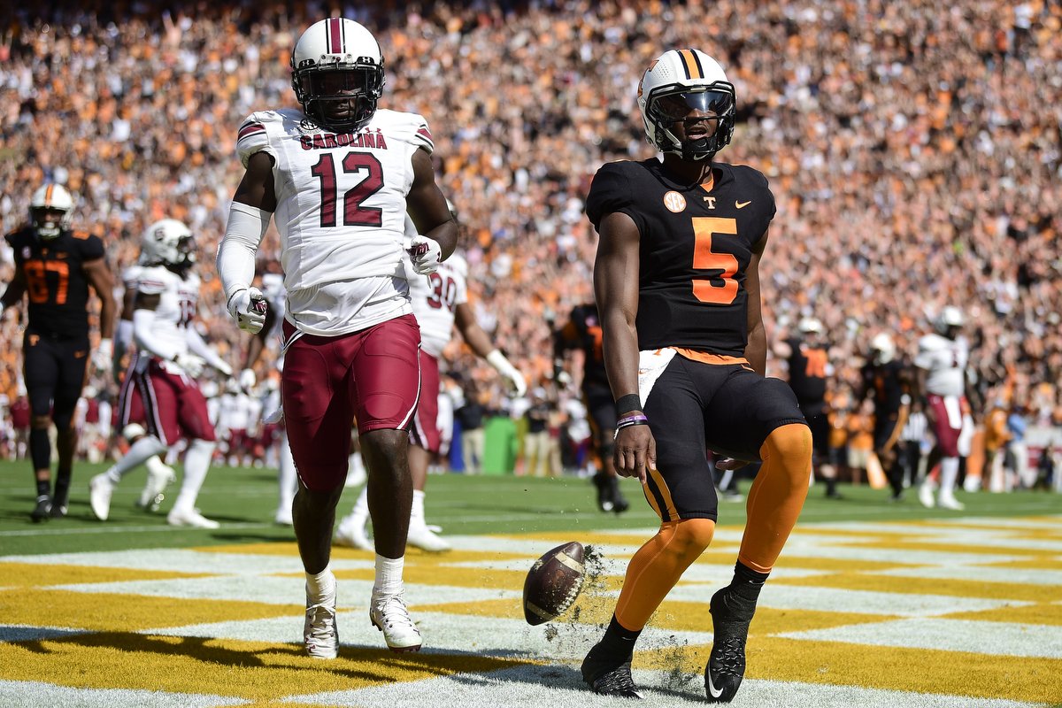  Tennessee quarterback Hendon Hooker (5) scores a touchdown in the end zone as South Carolina defensive back Jaylan Foster (12) during an NCAA college football game between the Tennessee Volunteers and the South Carolina Gamecocks in Knoxville. 