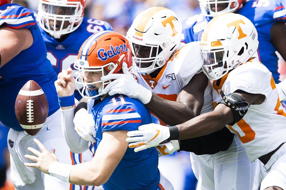  Florida linebacker Mohamoud Diabate (11) fumbles the ball while being tackled by Tennessee linebacker Daniel Bituli (35) and defensive back Bryce Thompson (20) during an SEC football game between Tennessee and Florida at Ben Hill Griffin Stadium in 