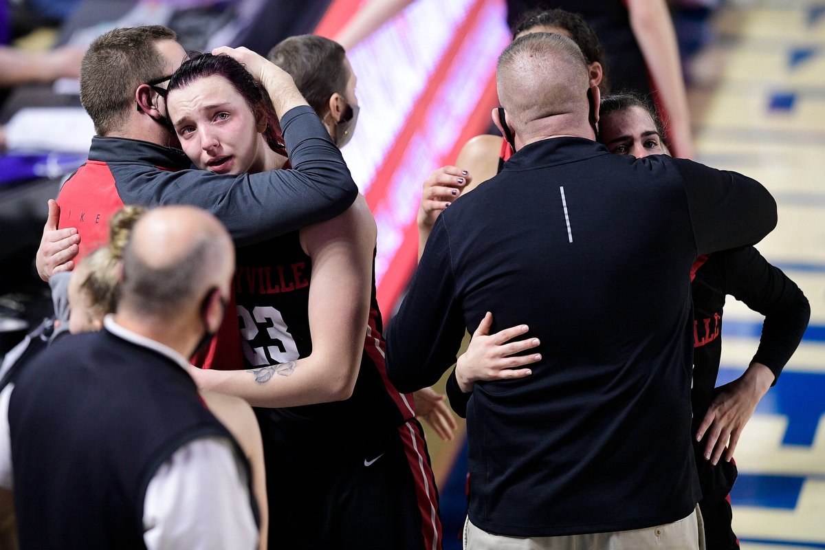  Maryville's Denae Fritz (23) and Maryville's Gracie Midkiff (12) are comforted by coaches after losing to Blackman during the TSSAA girls basketball state tournament at Middle Tennessee State University. 